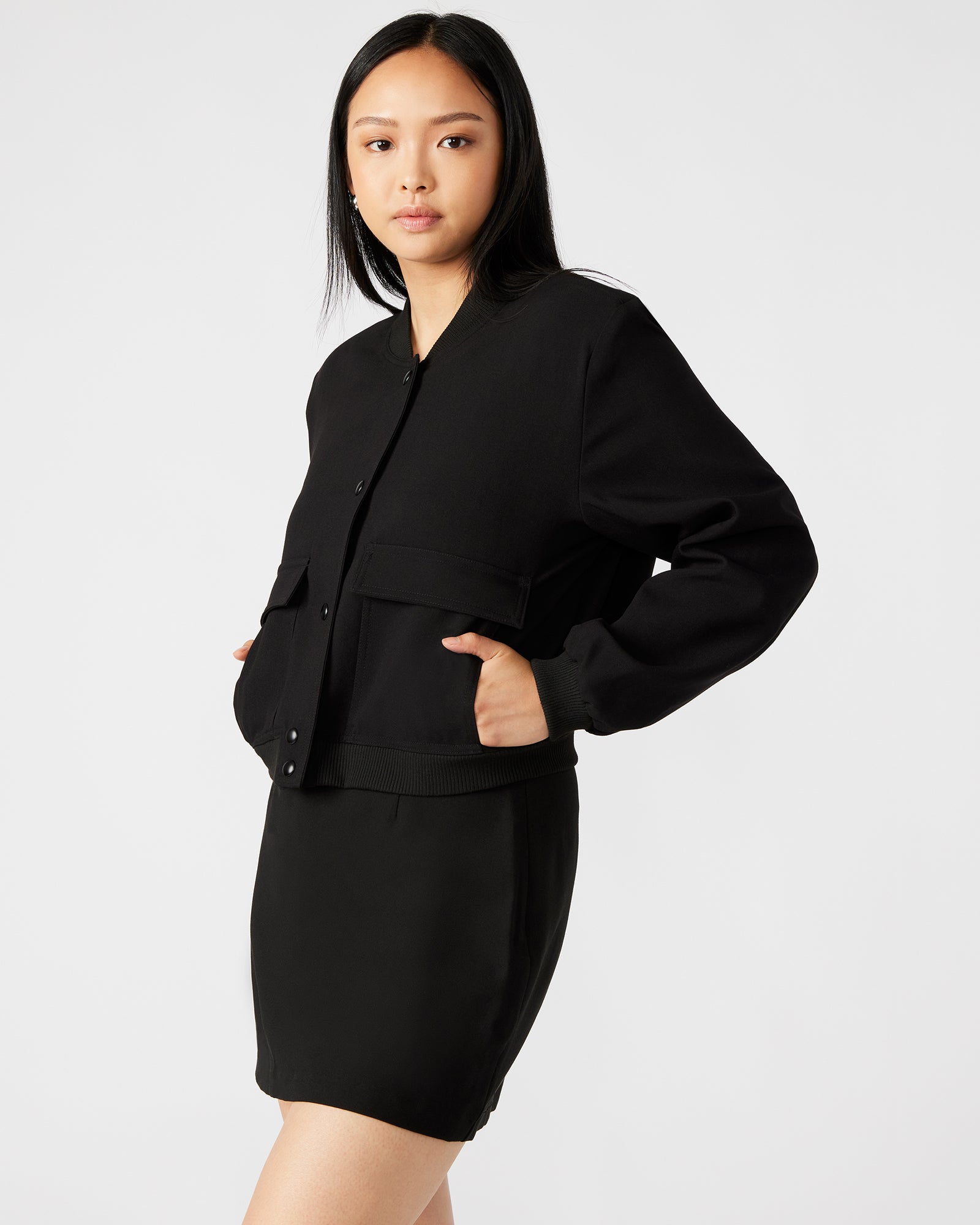 Model showcasing the bomber jacket with functional pockets.