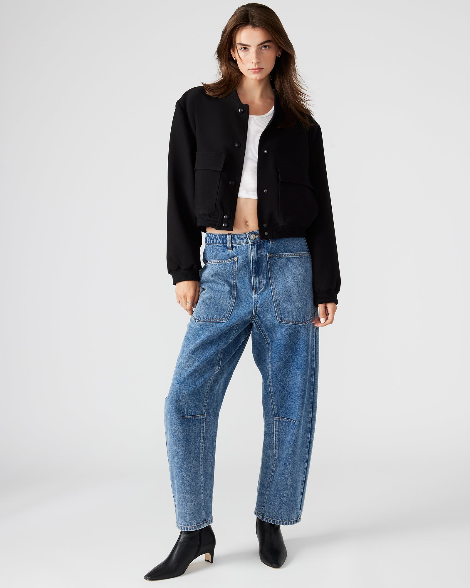 Model showcasing the bomber jacket with functional pockets.