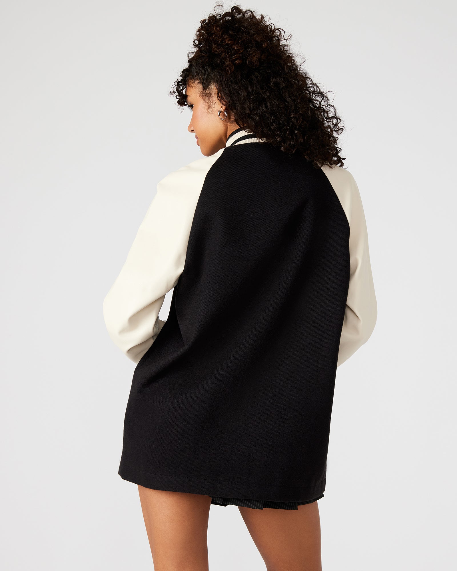 Close-up of SKYLIE black varsity jackets ribbed collar and snap buttons