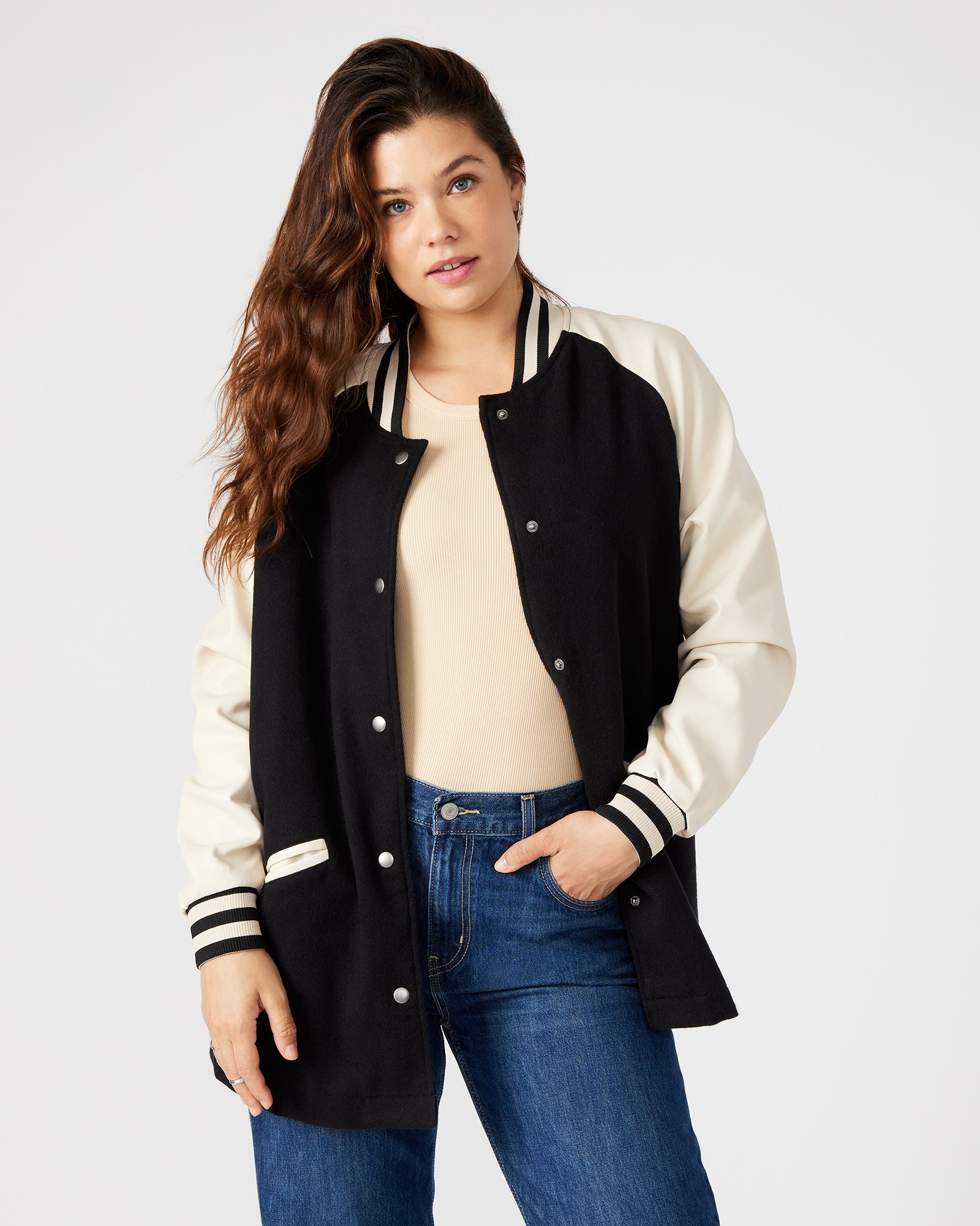 Close-up of SKYLIE black varsity jacket's ribbed collar and snap buttons