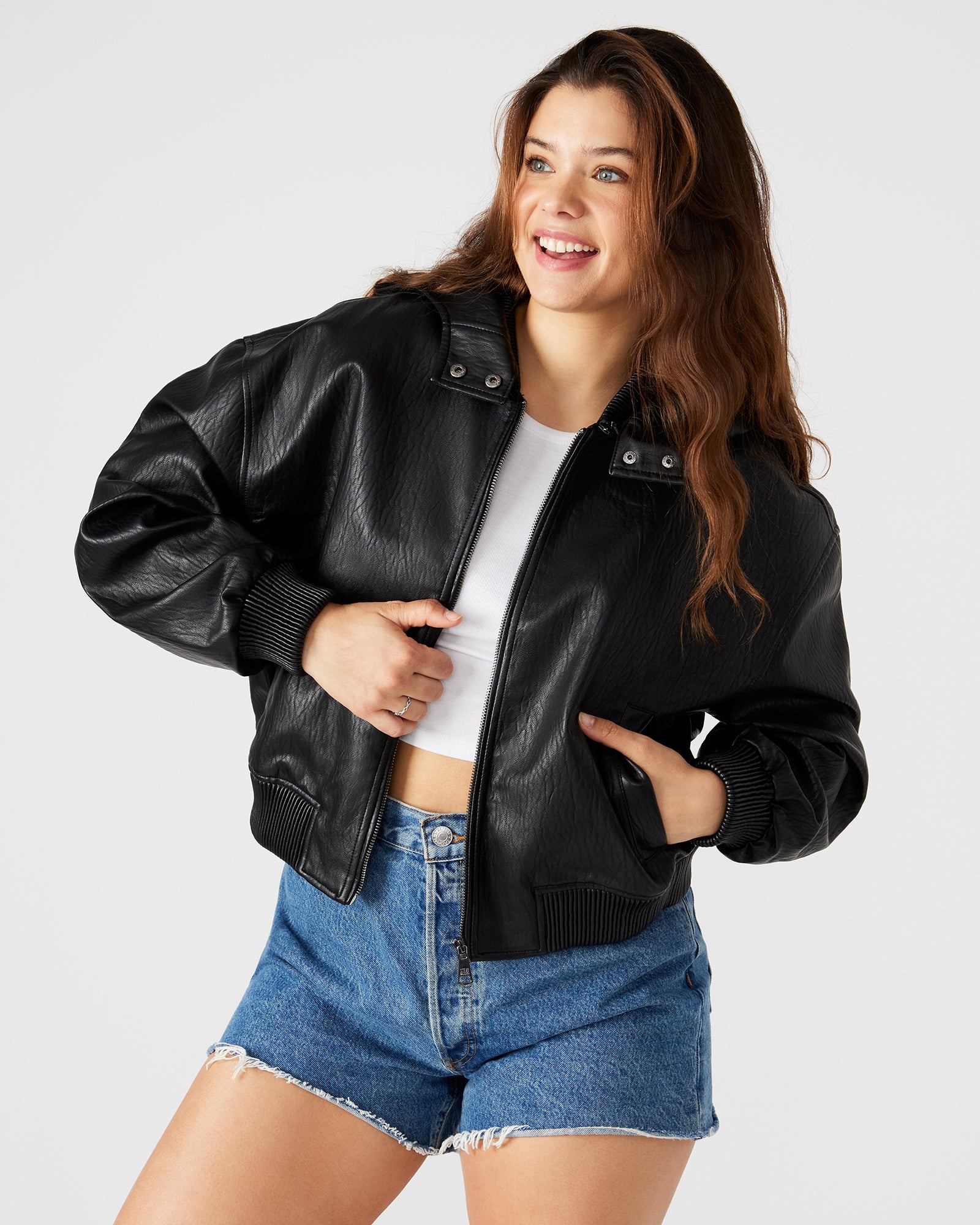 Side profile of woman wearing faux leather cropped jacket