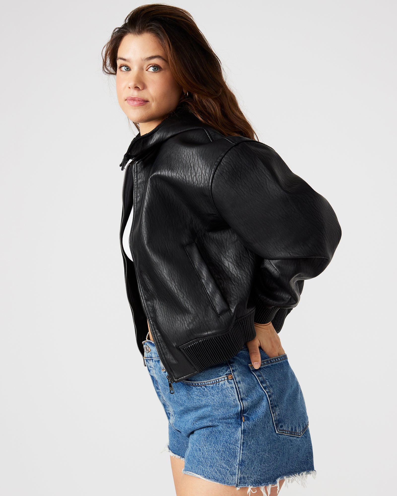 Detail shot of zipper and pocket on black bomber jacket