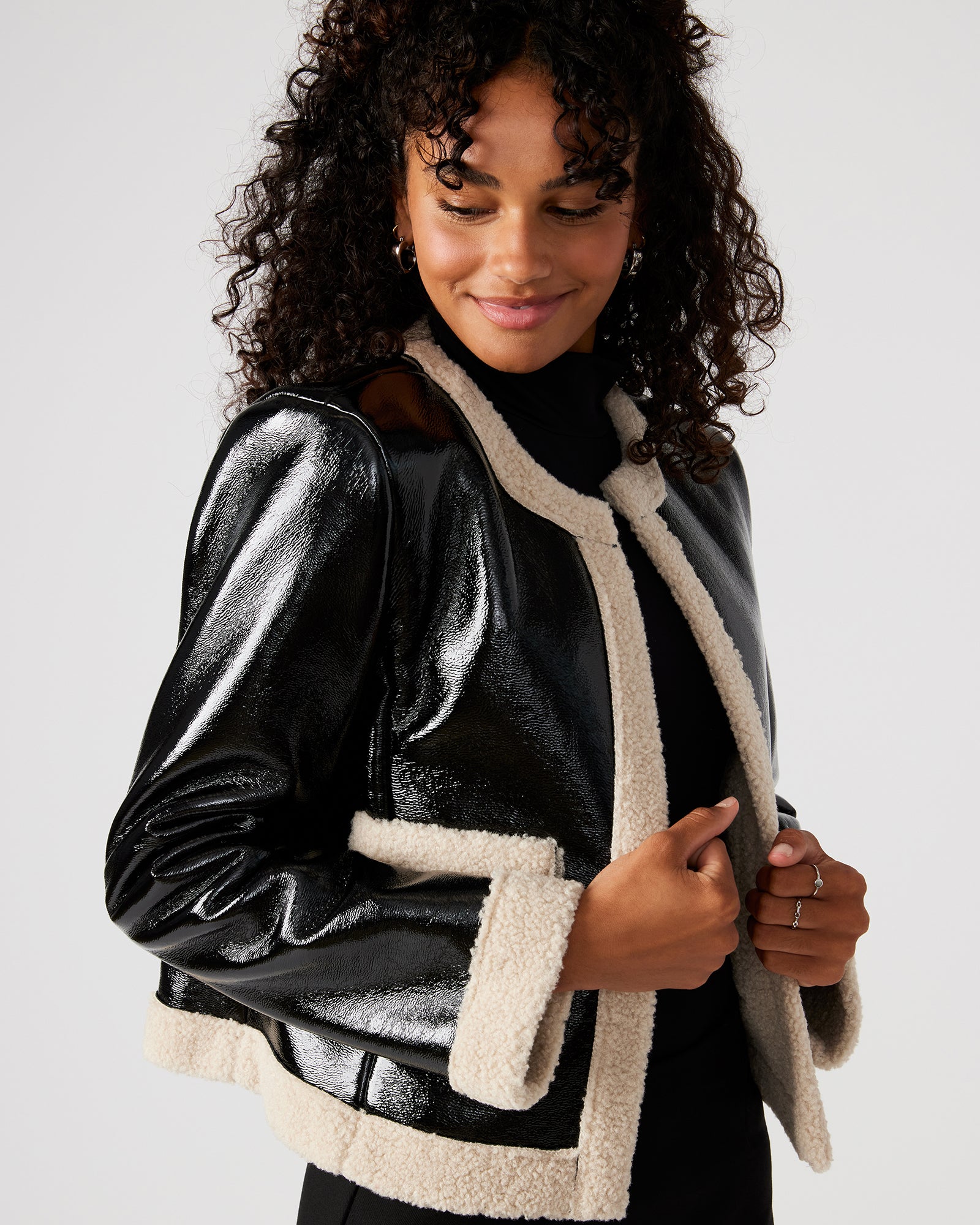 Side view of the womens faux leather sherpa jacket, highlighting the functional pockets.
