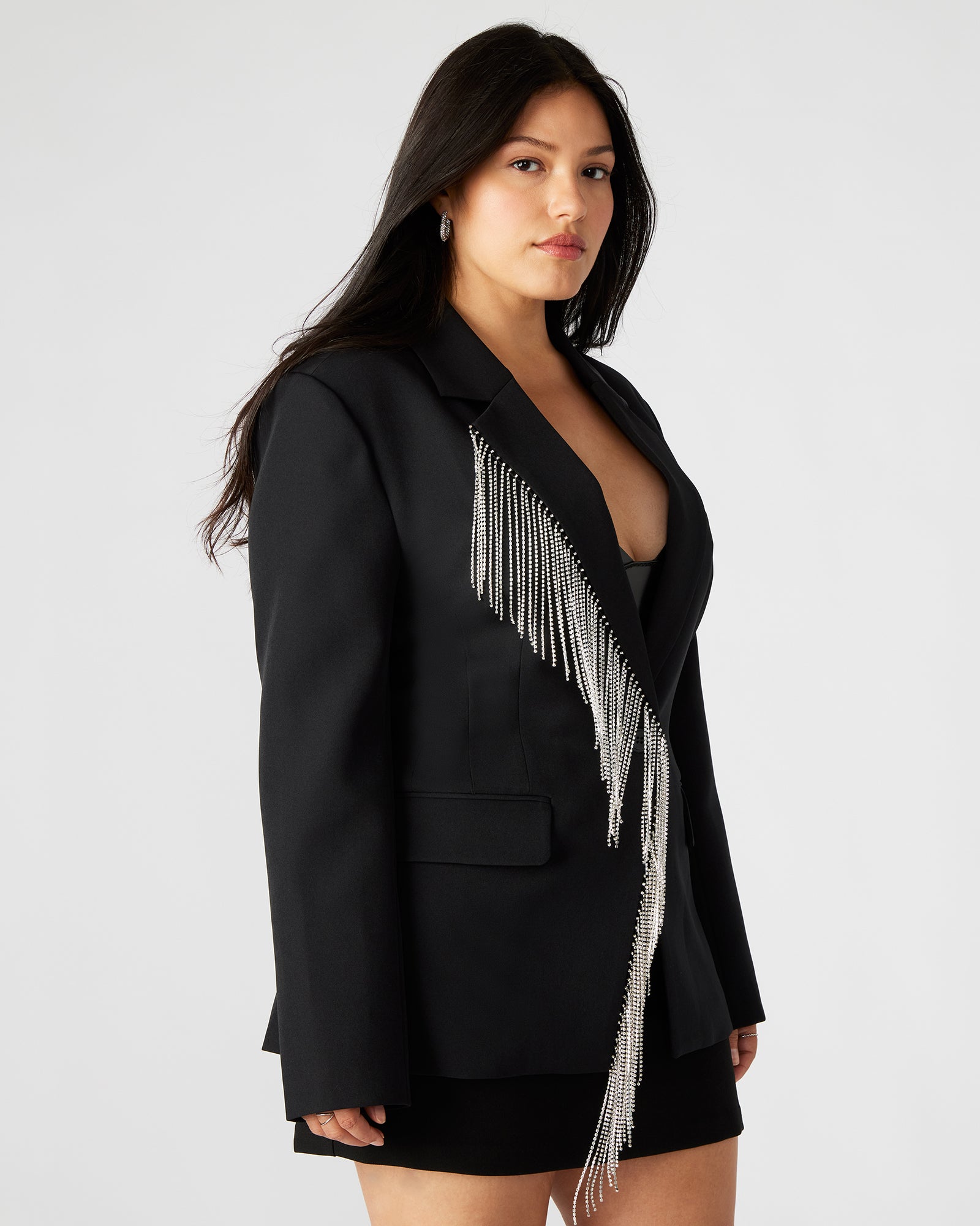 Close-up of rhinestone detailing on tweed-like texture of the suit blazer