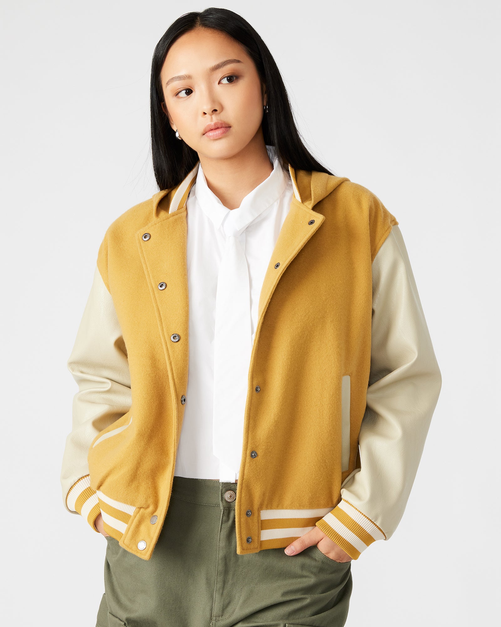 Close-up of the hooded varsity jacket with mustard color and leather sleeves