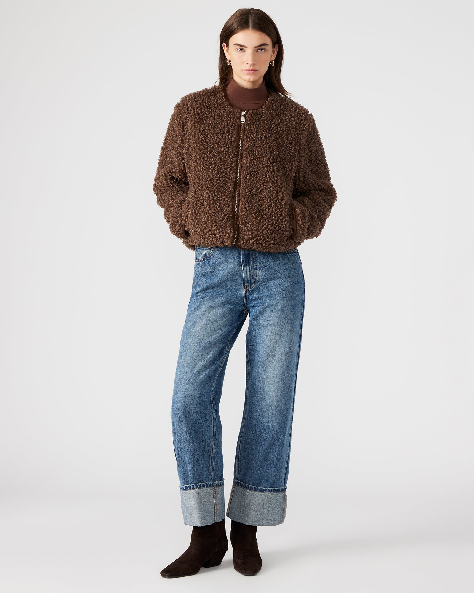 Side view showing the jackets tailored fit and textured brown suede fabric