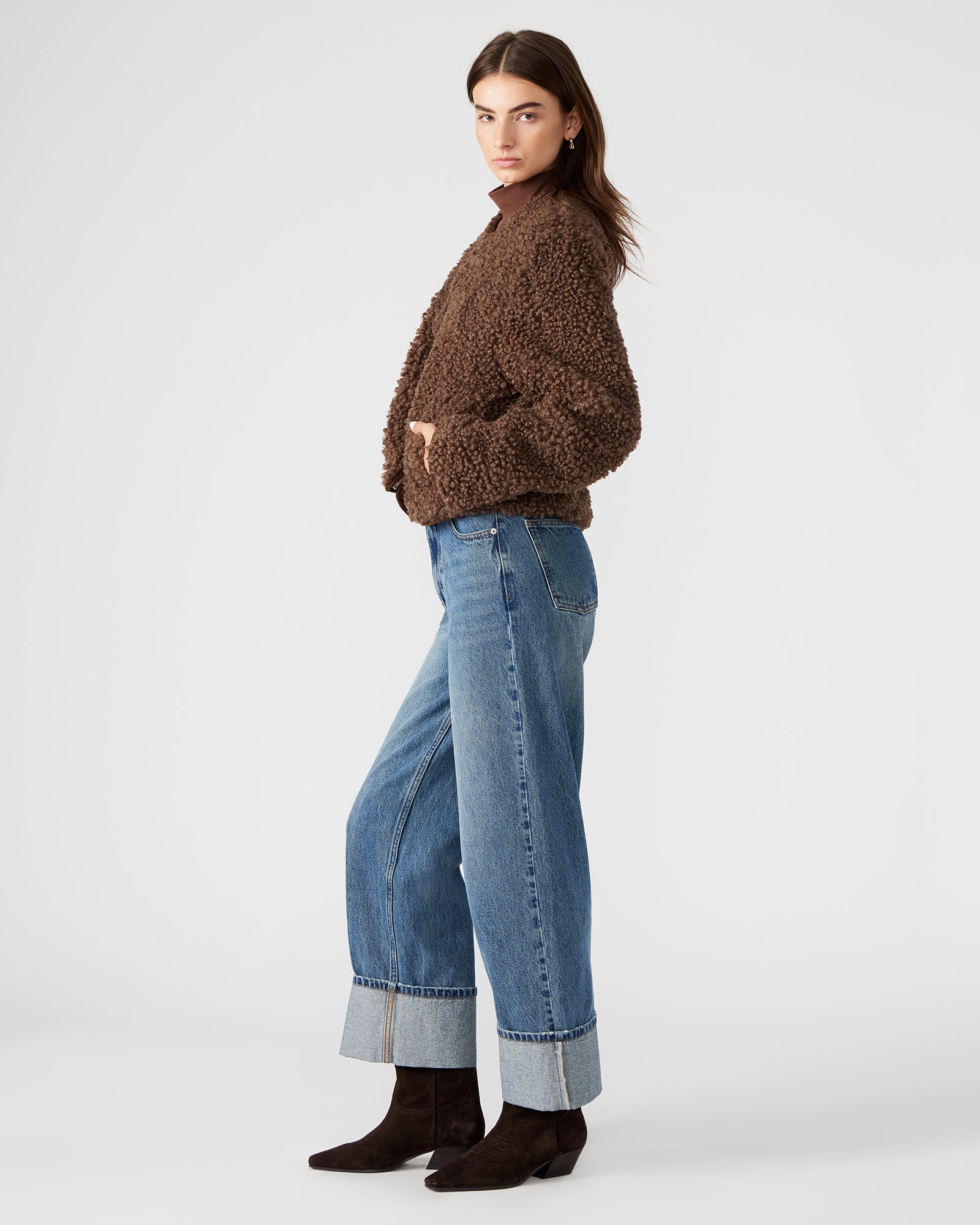 Full-body shot of the sherpa jacket styled with jeans for a casual winter look