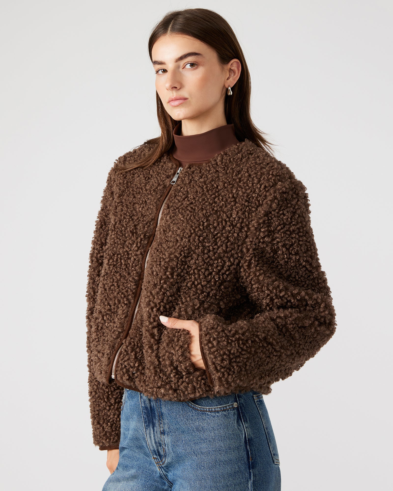 Full-body shot of the sherpa jacket styled with jeans for a casual winter look