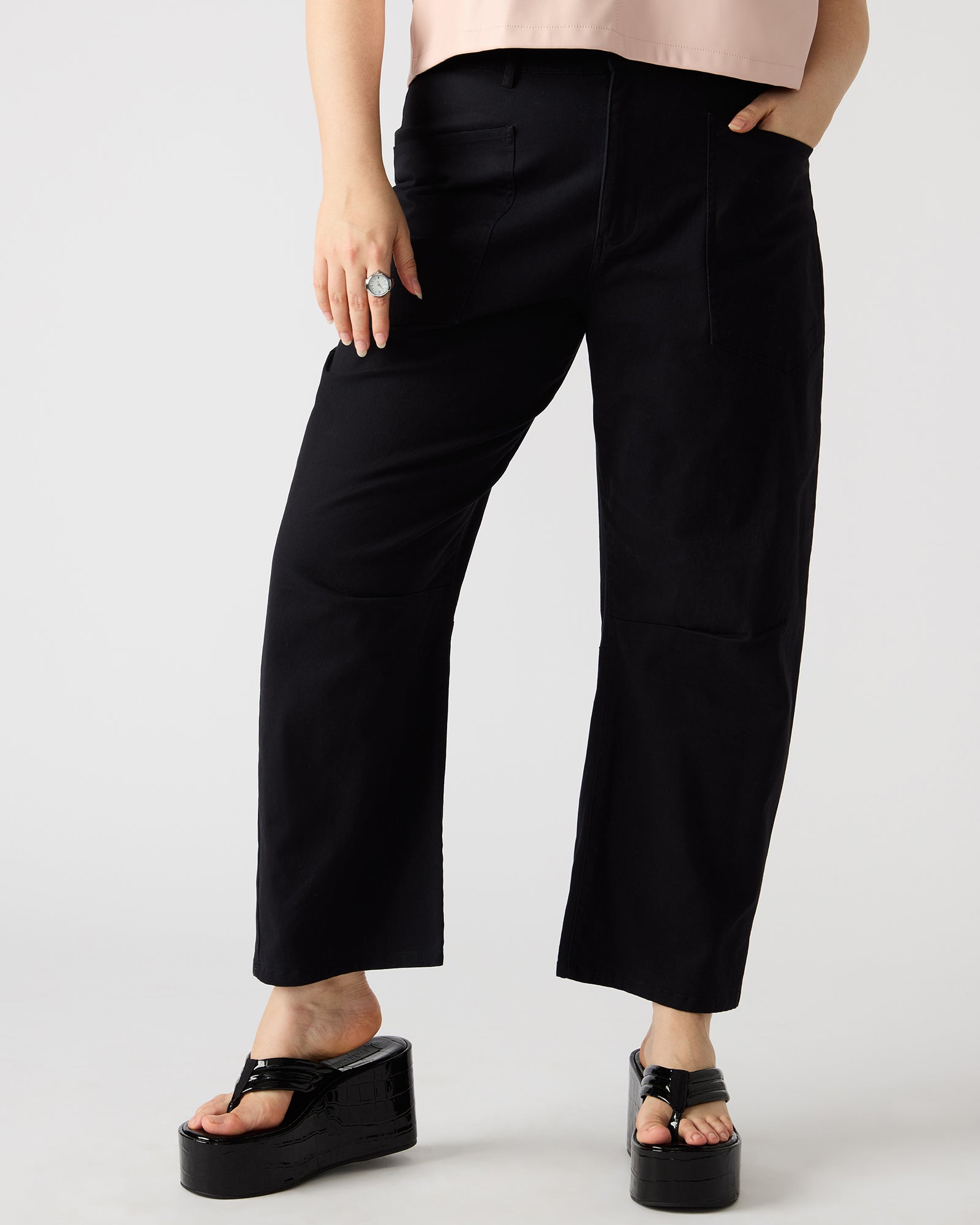 Close-up of the fabric texture of cotton twill barrel leg pants, highlighting the stretch material.