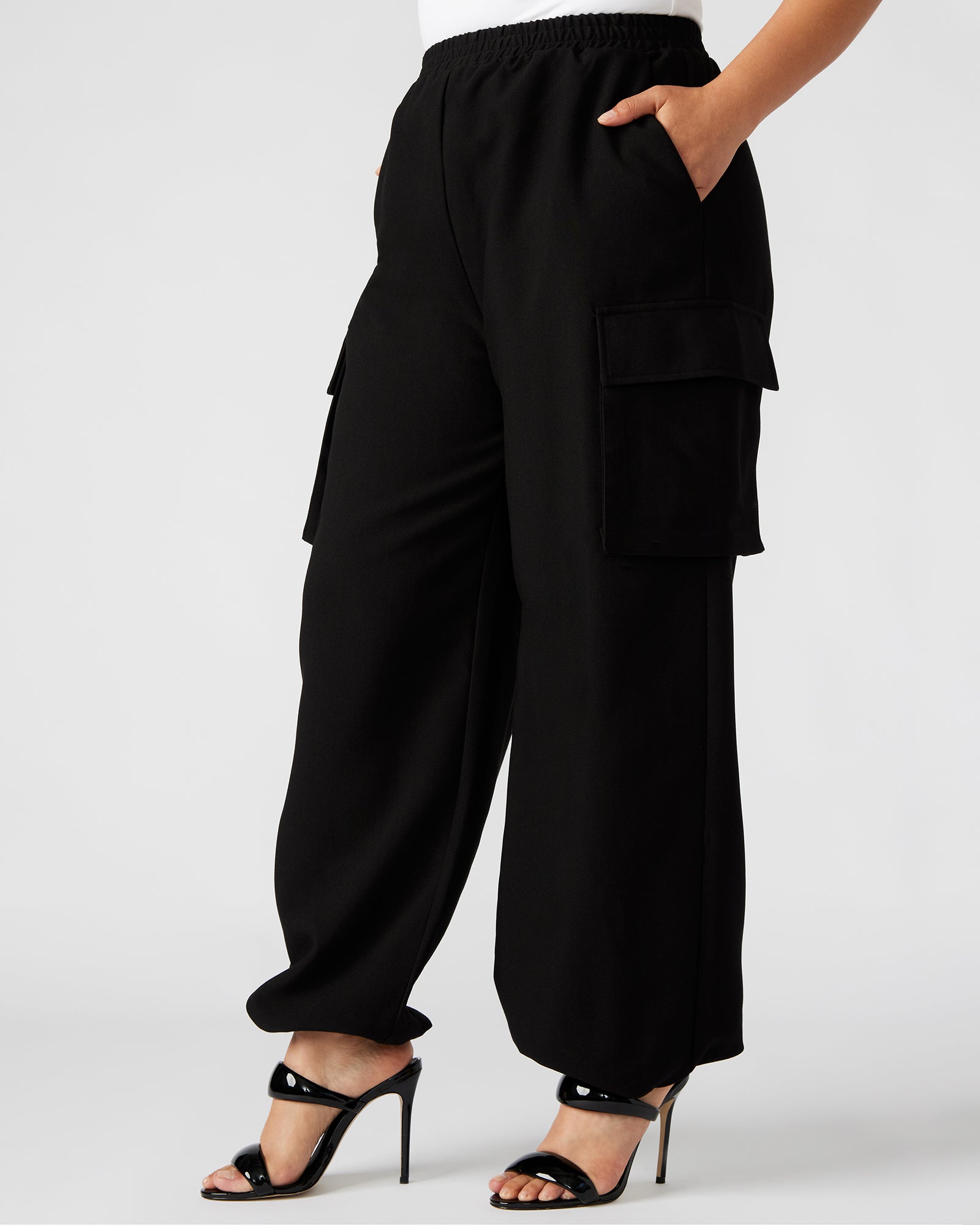 Side view of womens cargo pants worn on forest trail