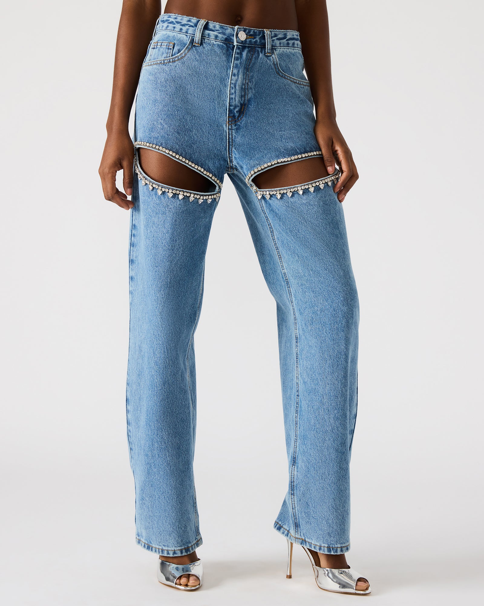 Side angle of womens black jeans, highlighting the wide-leg fit and embellishments