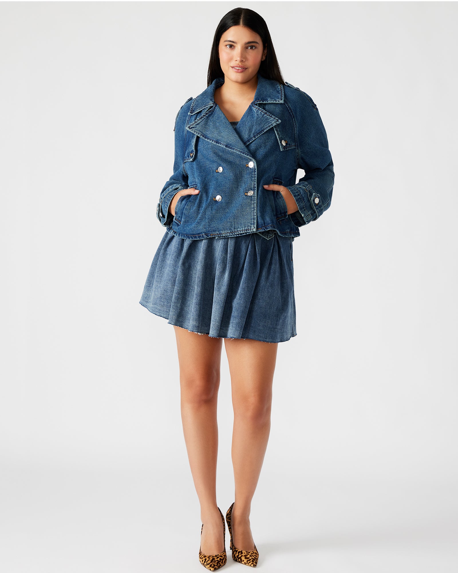 Back view of the SIRUS cropped denim jacket, showcasing the pleated back flap.