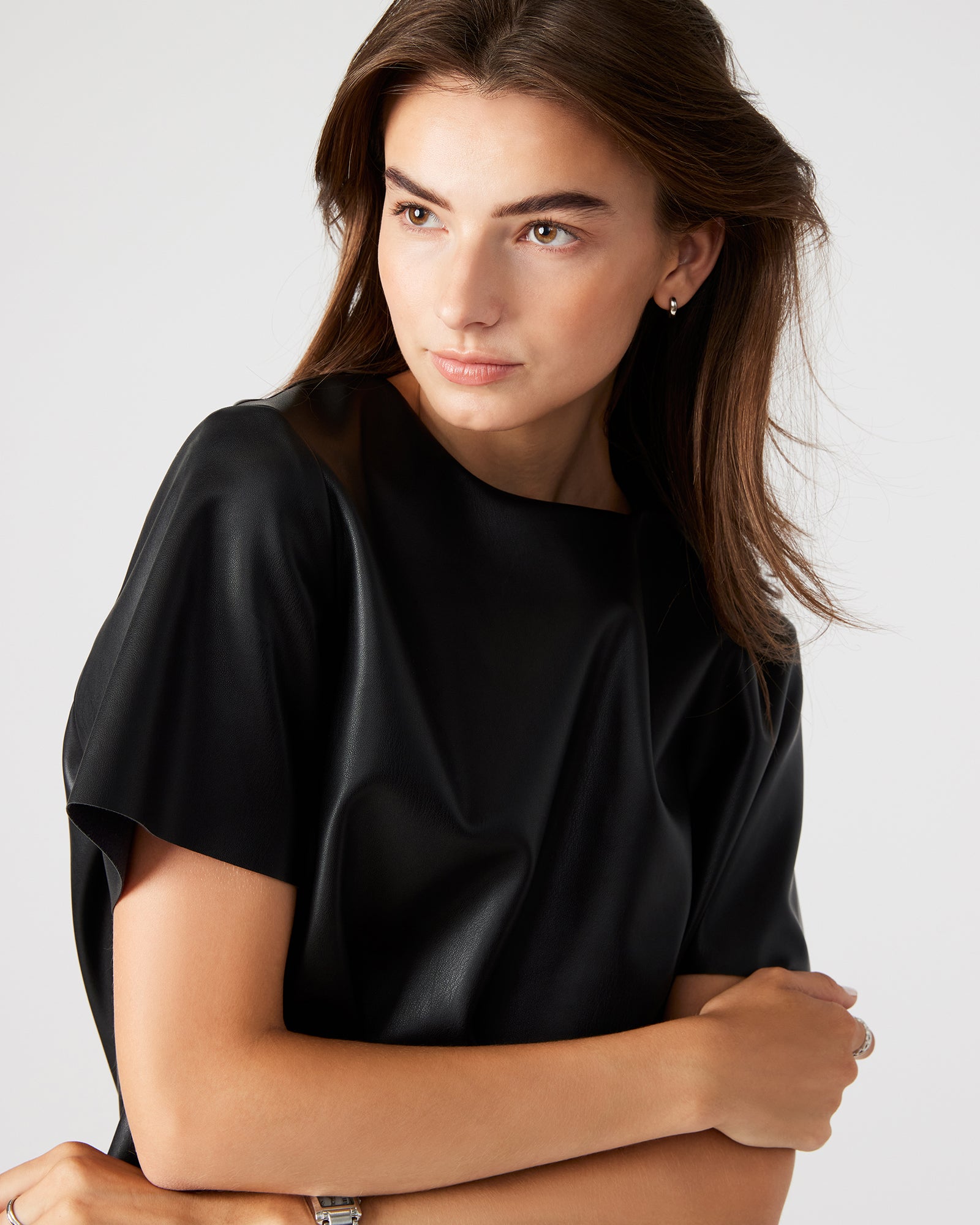 Front view of the Ezra faux leather top showcasing the zipper detail.
