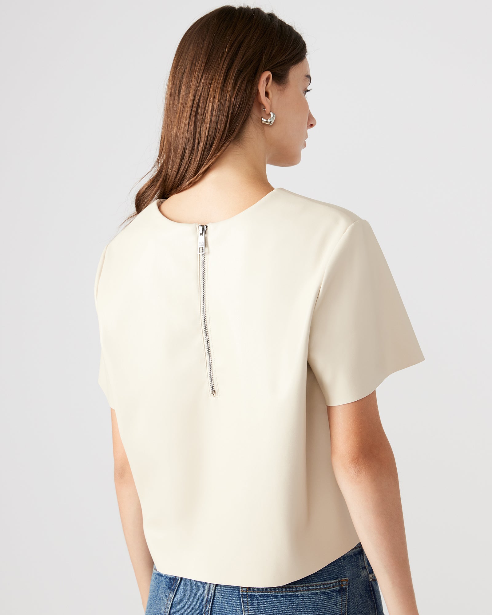 Close-up of the metal zipper closure on the faux leather top