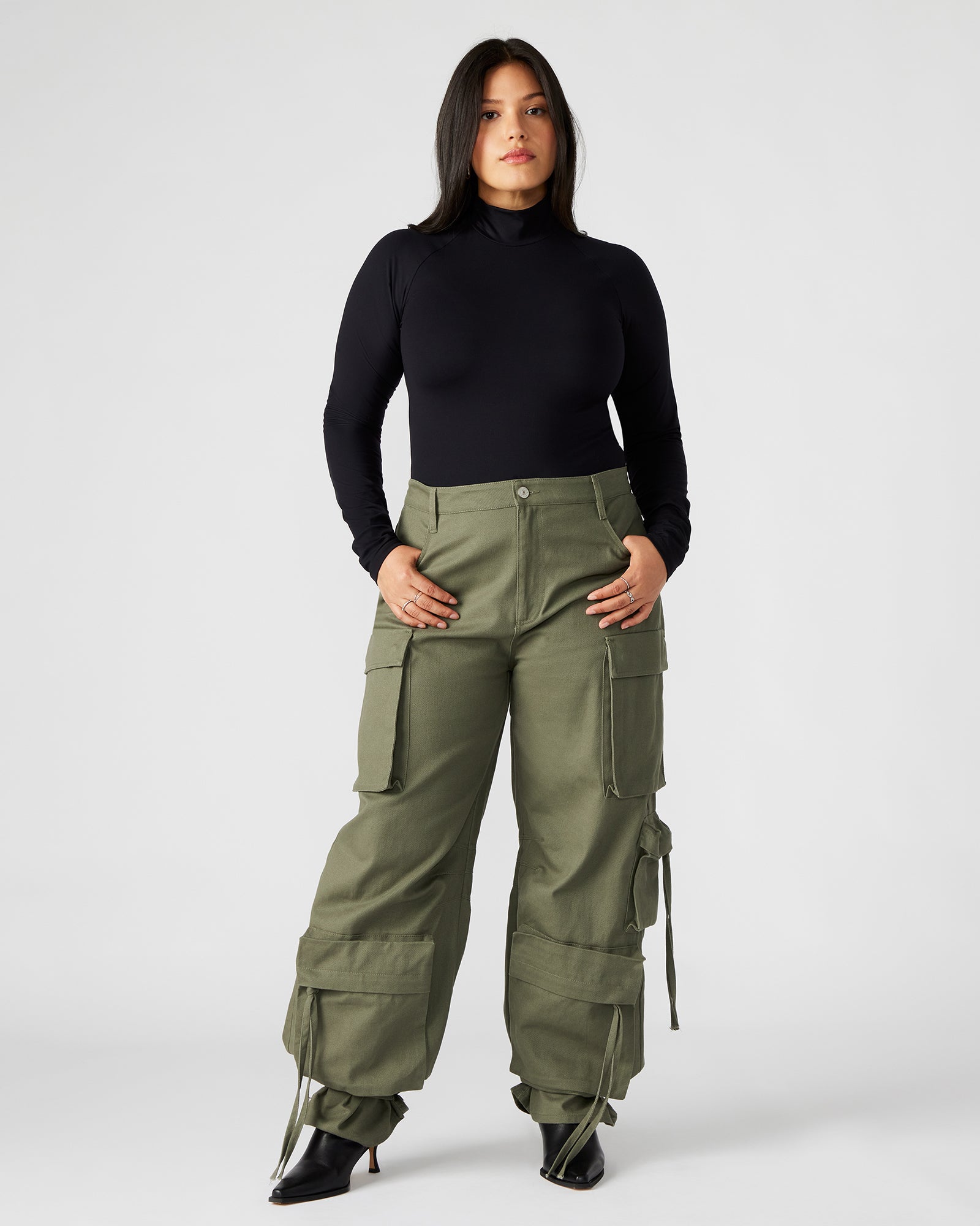 Model wearing the black bodysuit styled with jeans for casual wear