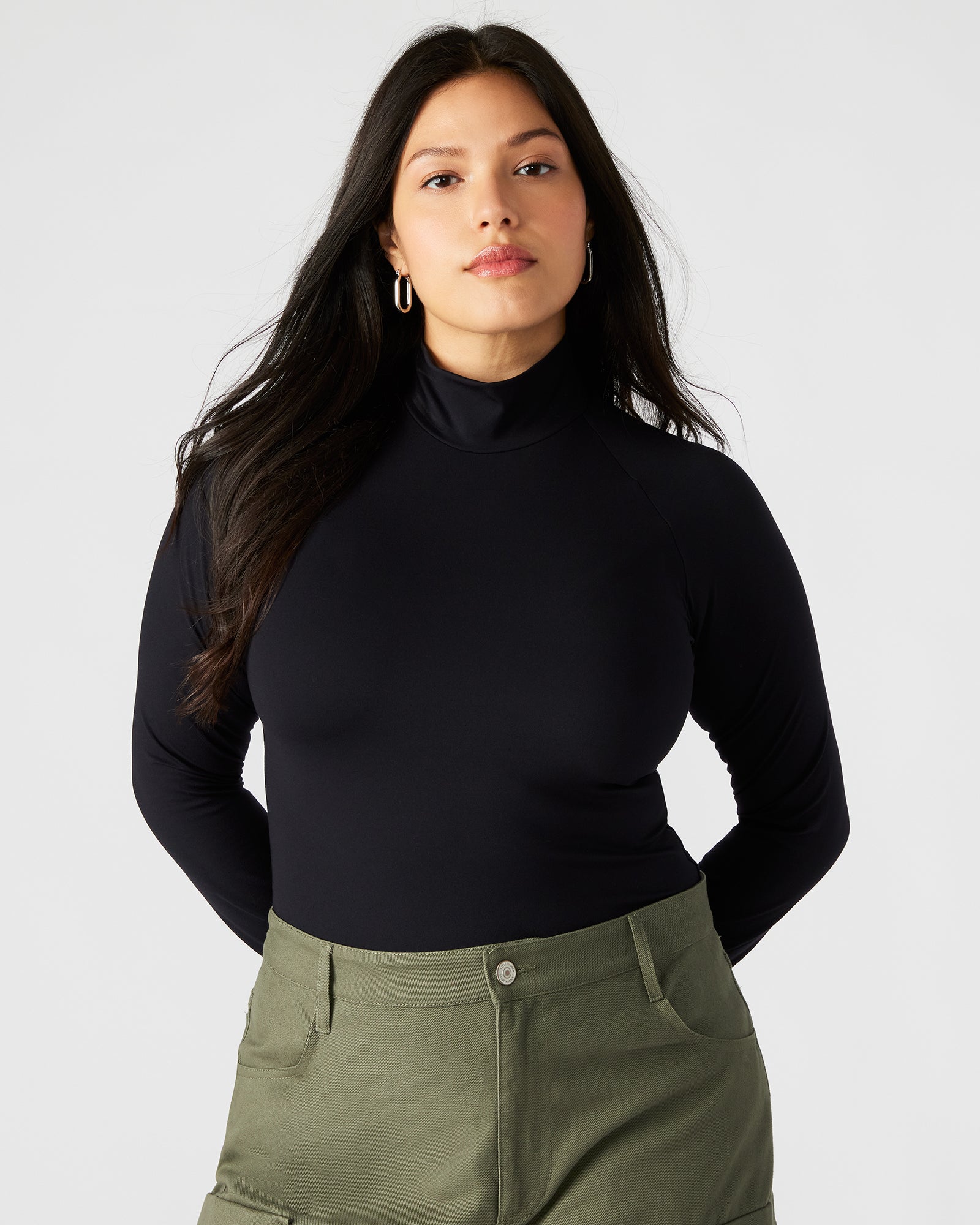 Model wearing the black bodysuit styled with jeans for casual wear