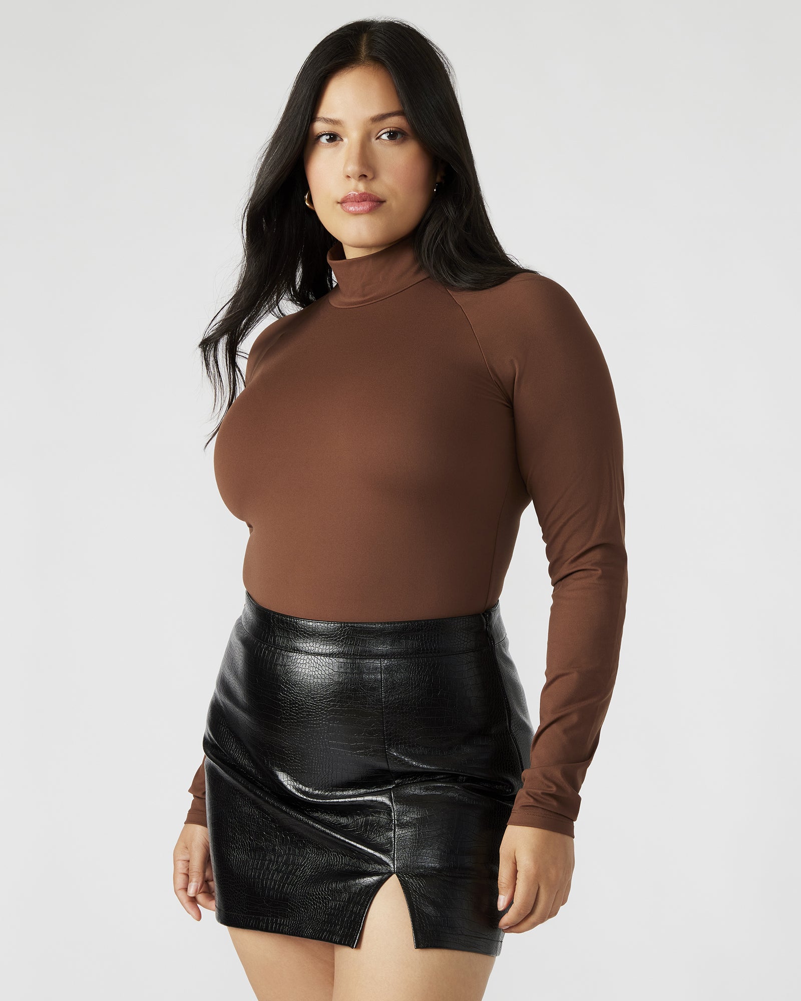 Close-up of the black mock neck long sleeve bodysuit highlighting the stretch fabric and sleek design