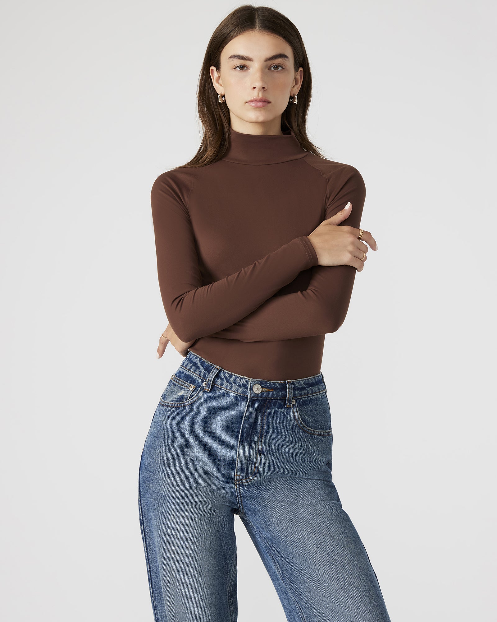 Model wearing the stretch bodysuit styled with jeans for a casual daytime look