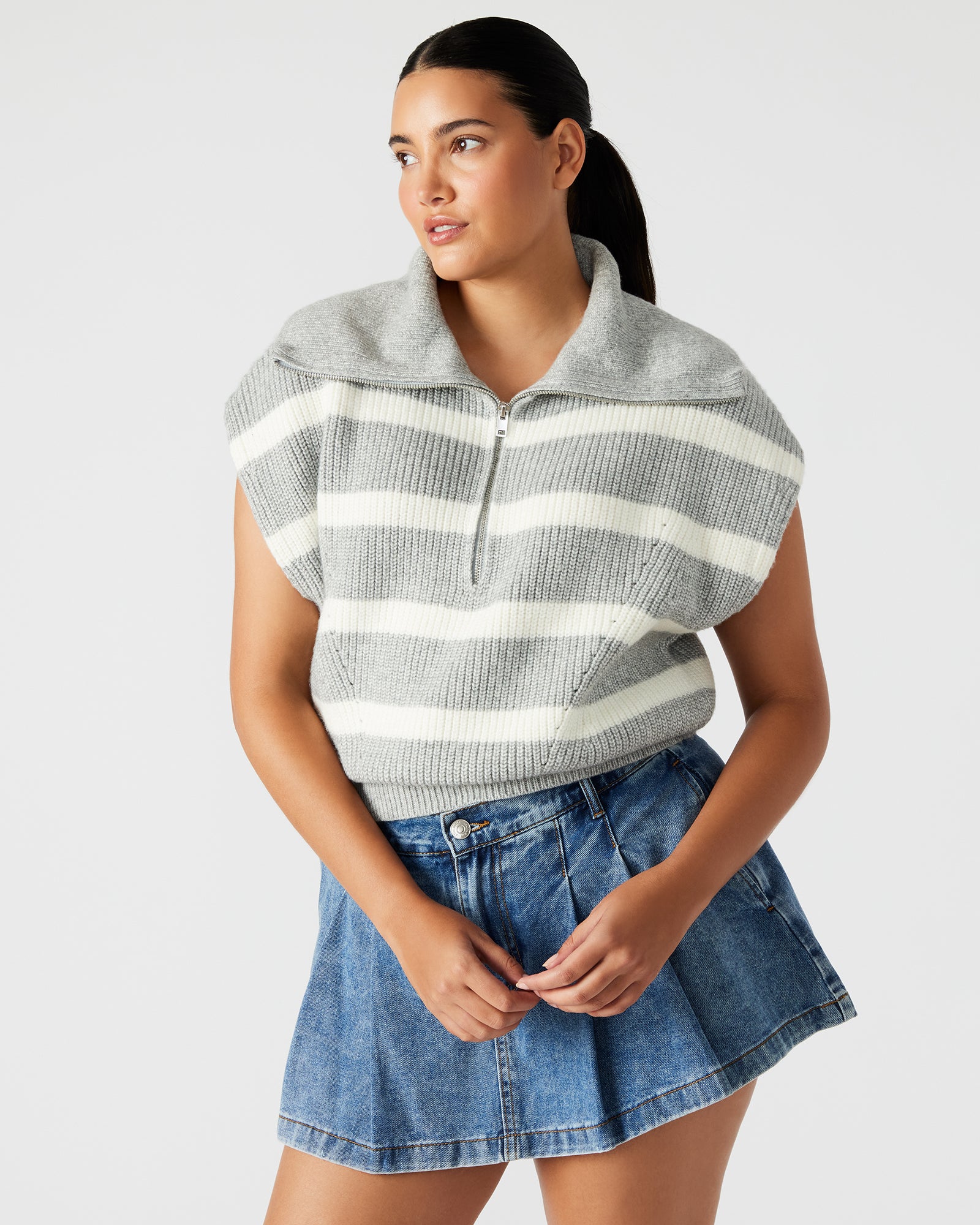 Front view of grey fashion sweater with hood and wide collar worn by model.