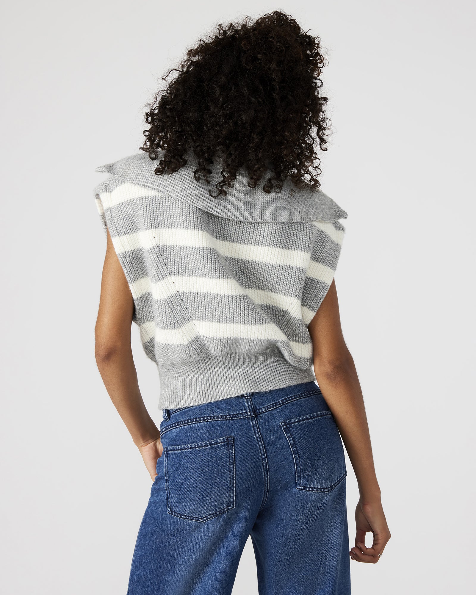 Front view of grey fashion sweater with hood and wide collar worn by model.