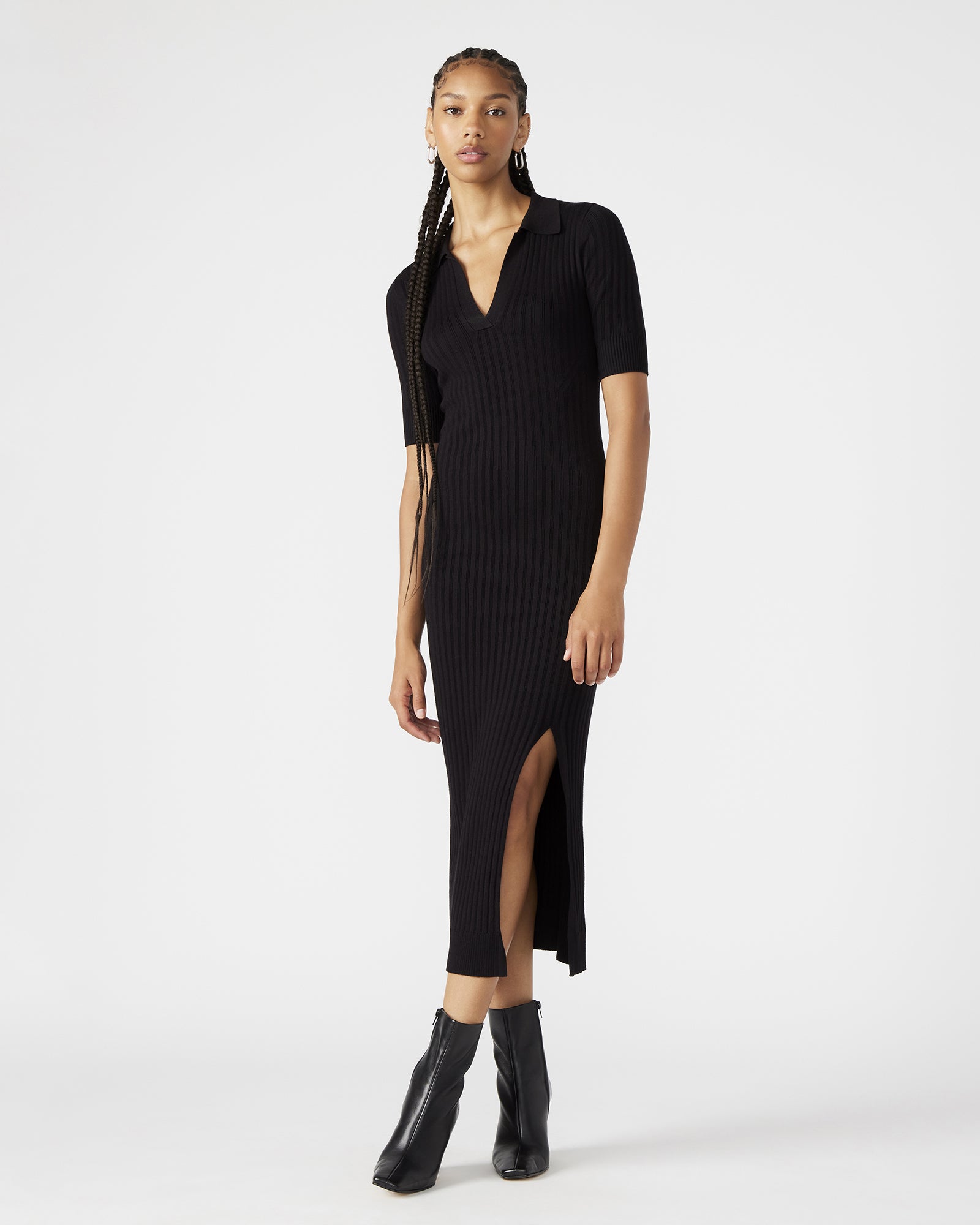 Close-up of the textured stitching on the black midi dress, highlighting its sophisticated design.