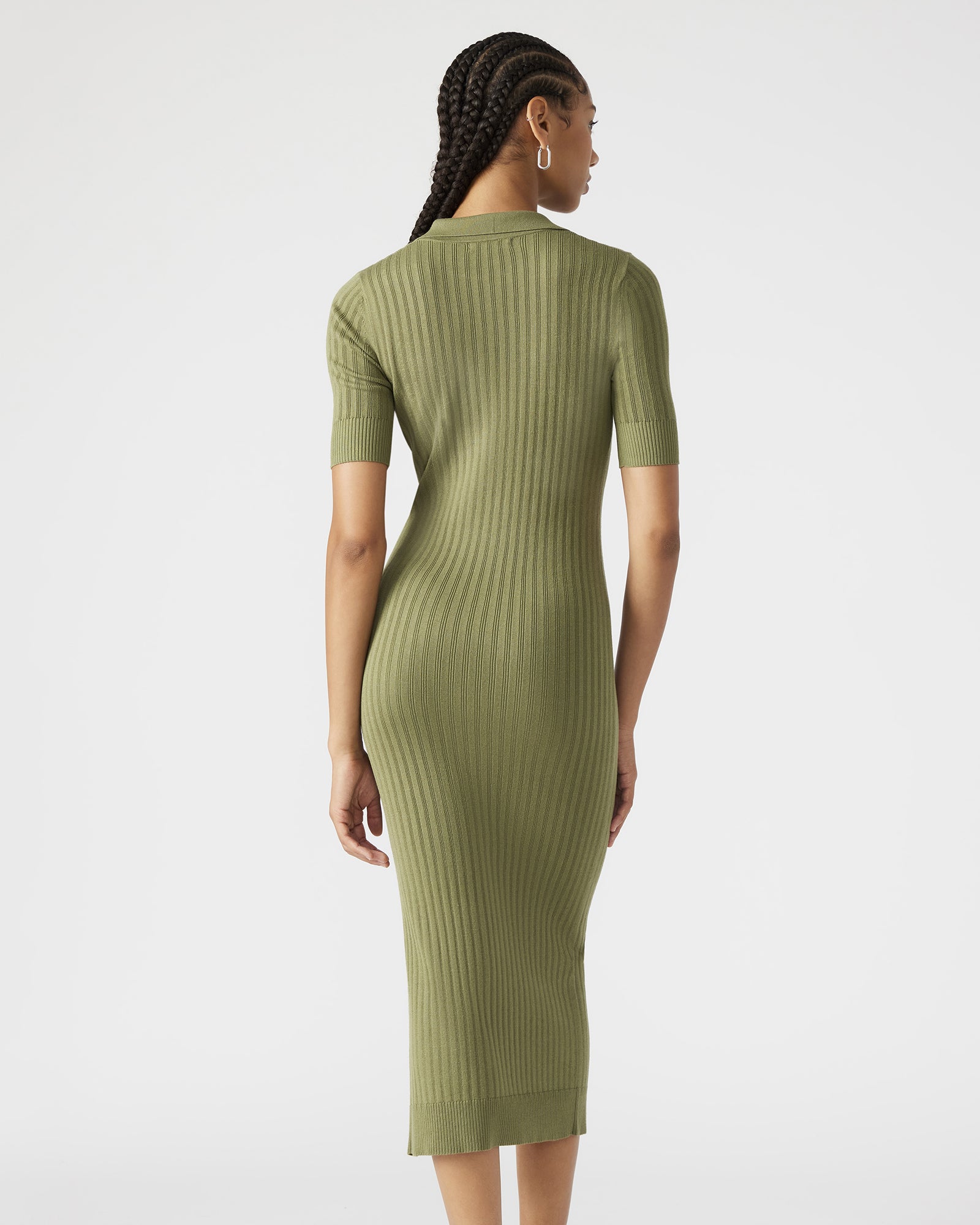Side view of the ribbed knit olive dress showcasing its front slit.