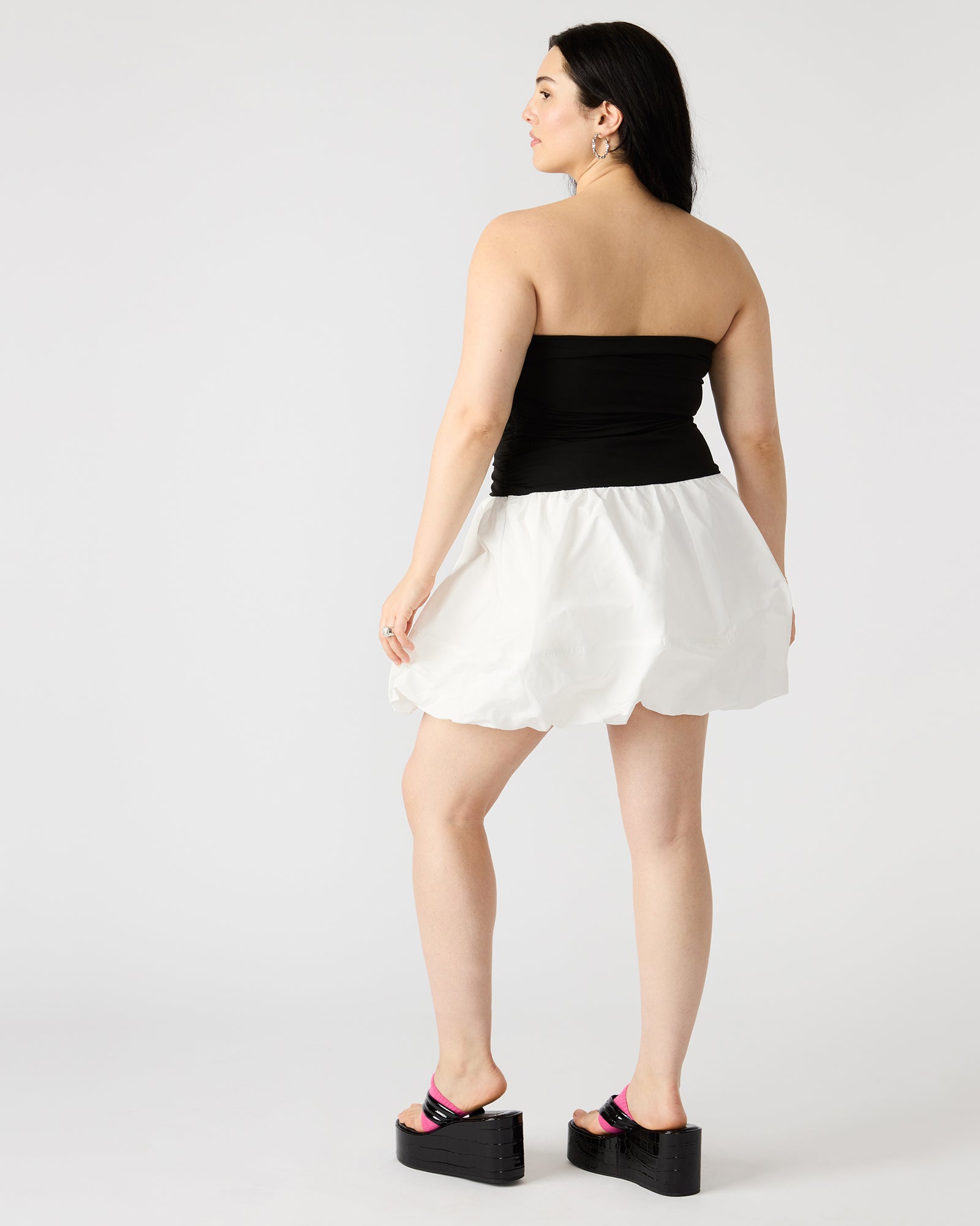 Front view of the Amari strapless mini dress in black and white, highlighting the bubble hem.