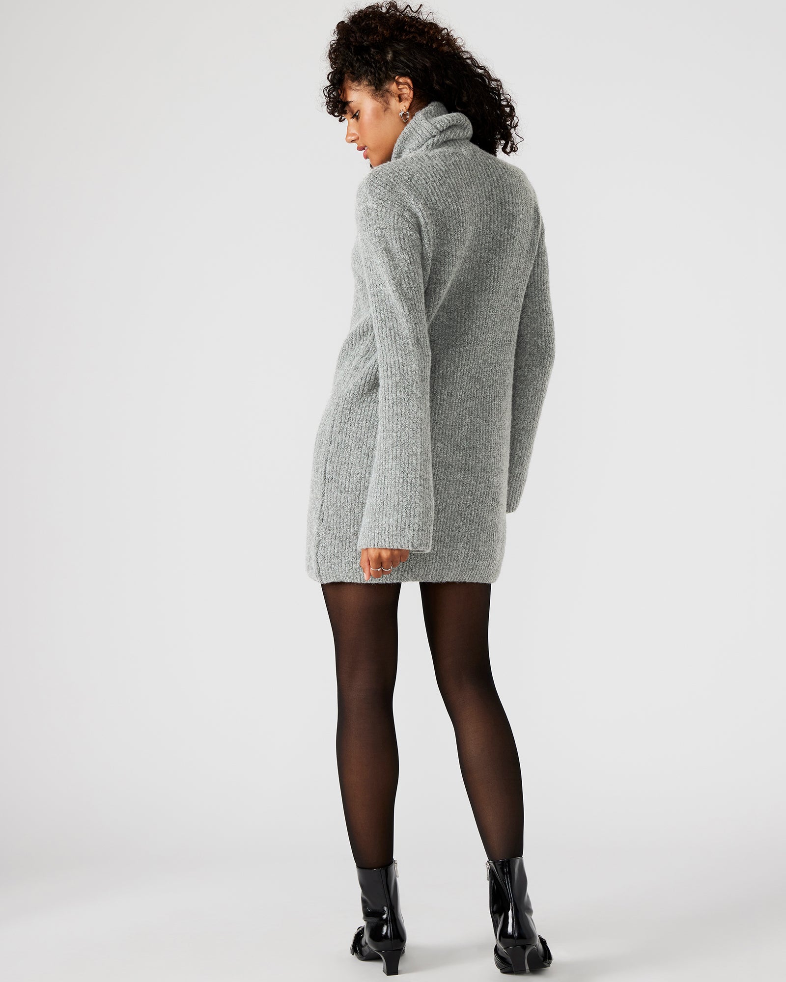Back view of the chic grey turtleneck sweater dress, perfect for layering.