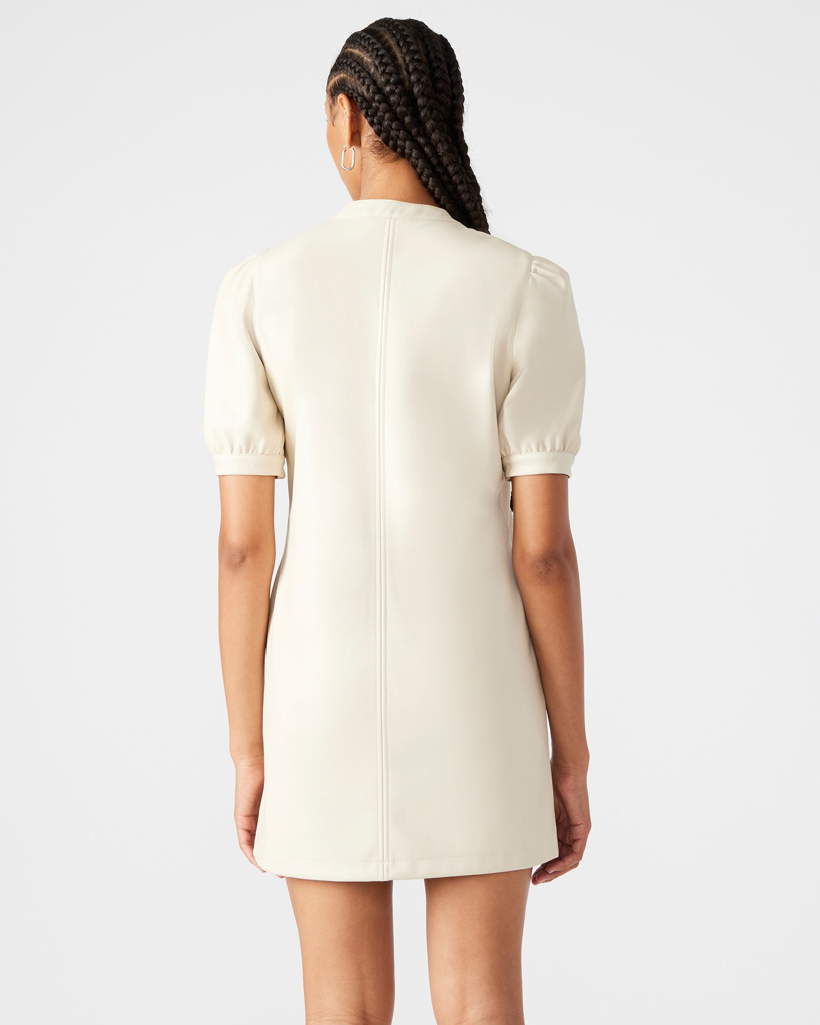Front angle of white puff sleeve mini dress with v-neck design