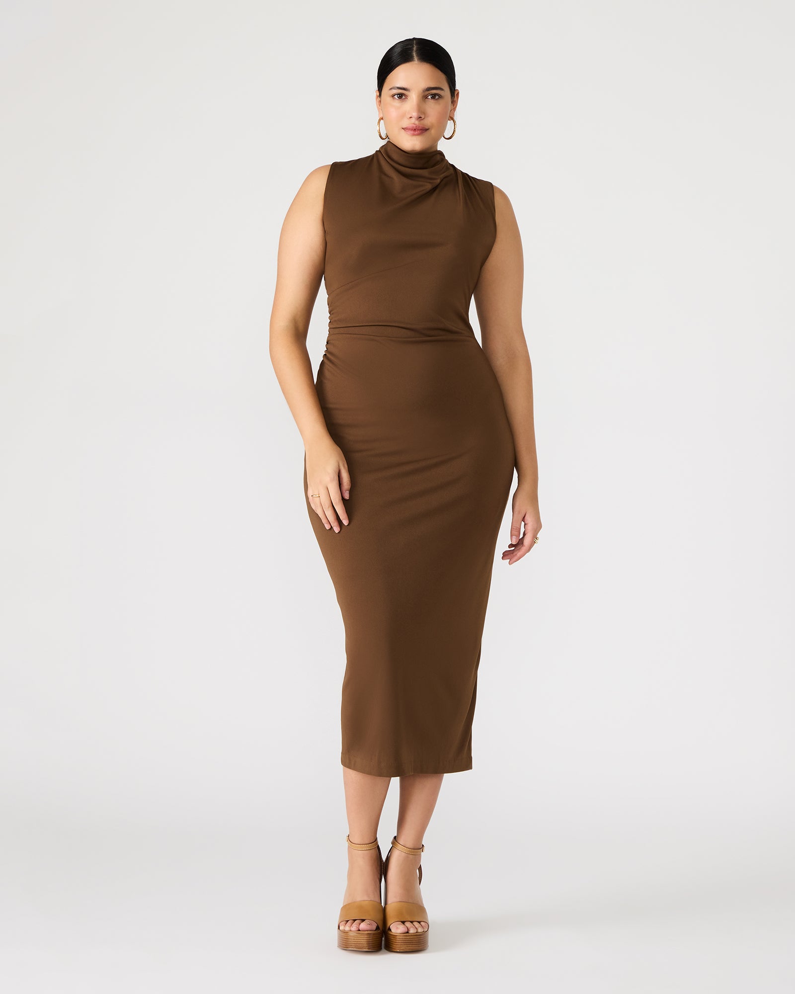 Model wearing a fitted brown midi dress with a mock neck.