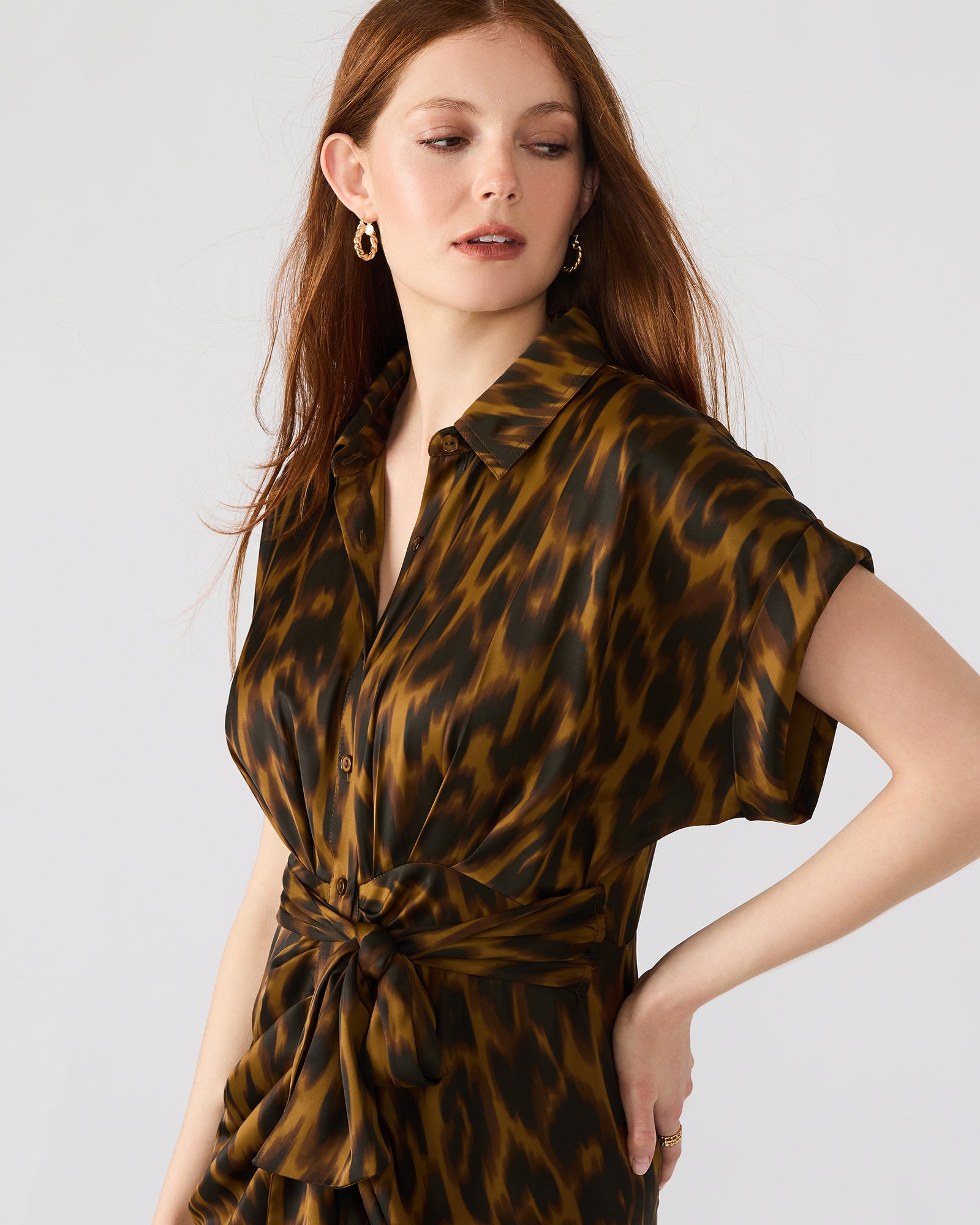 Close-up of satin texture and tie-front detail on leopard dress