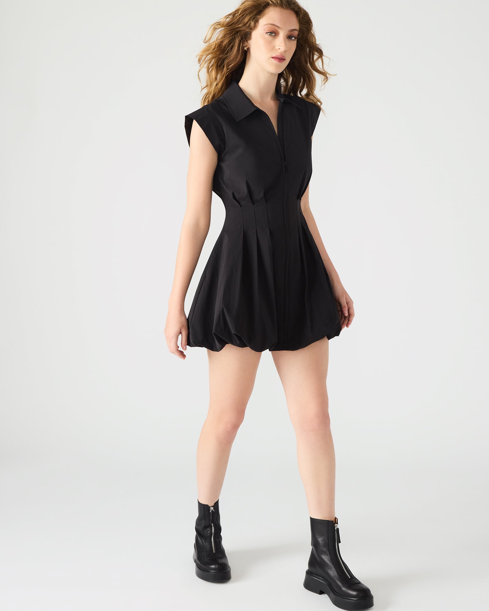 Model wearing the Dyanne black dress at a chic outdoor event.