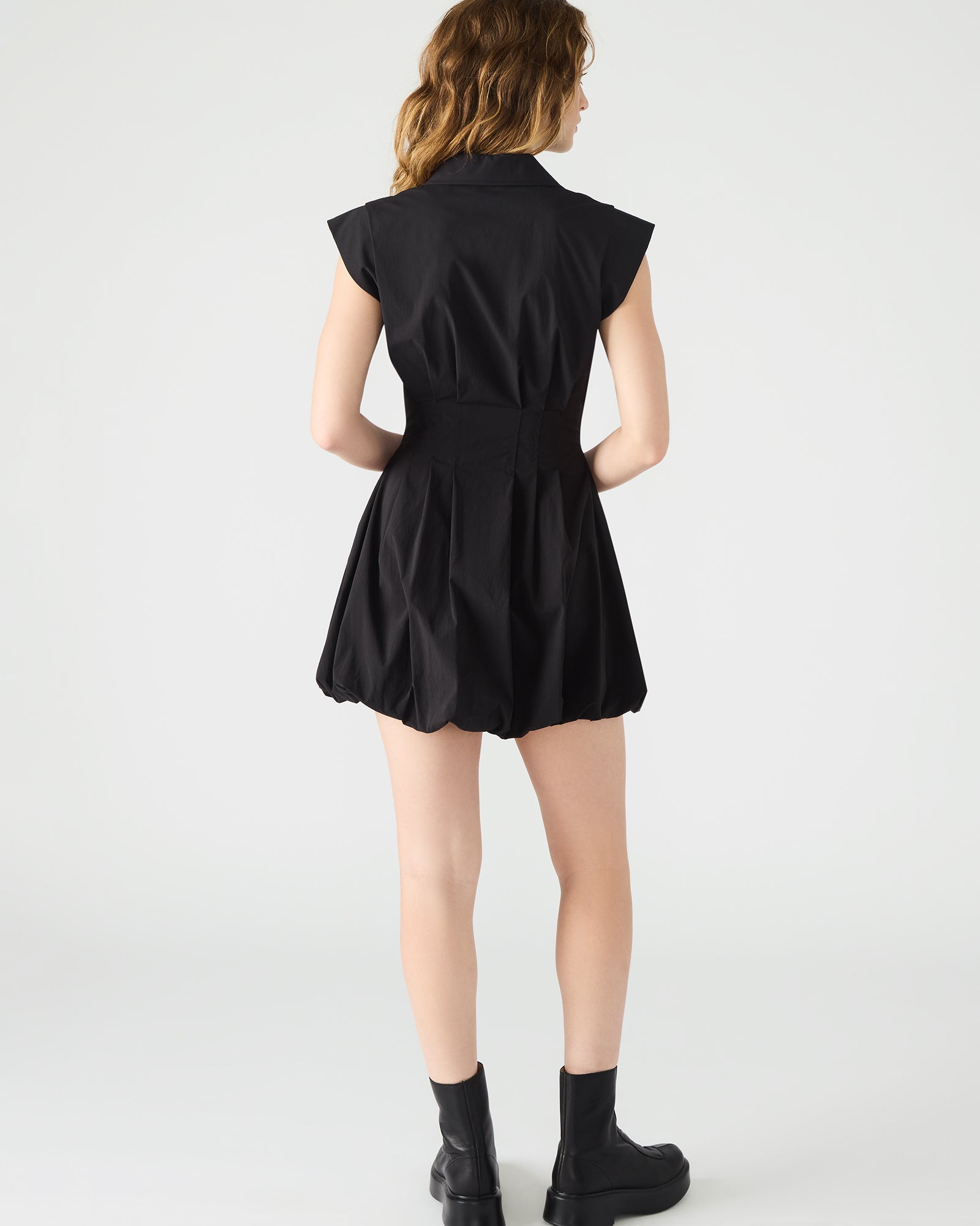 Front view of Dyanne black zip front mini dress showcasing the bubble hem.