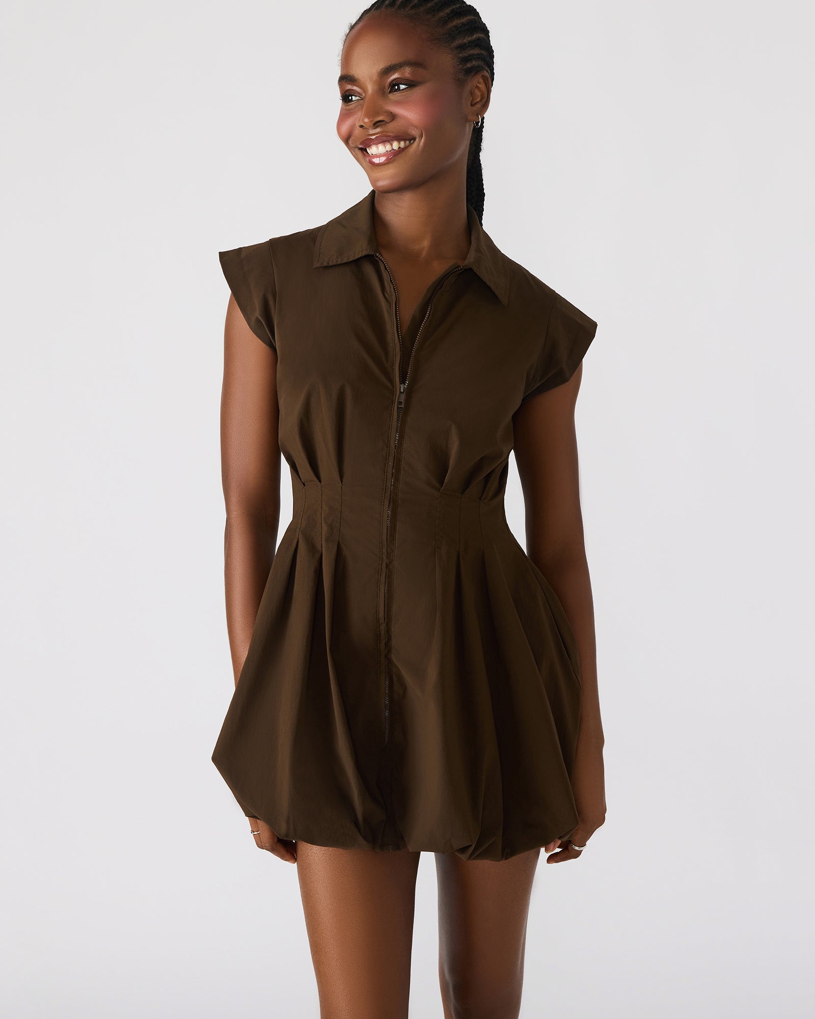 Street-style shot of the sequin mini dress styled with ankle boots