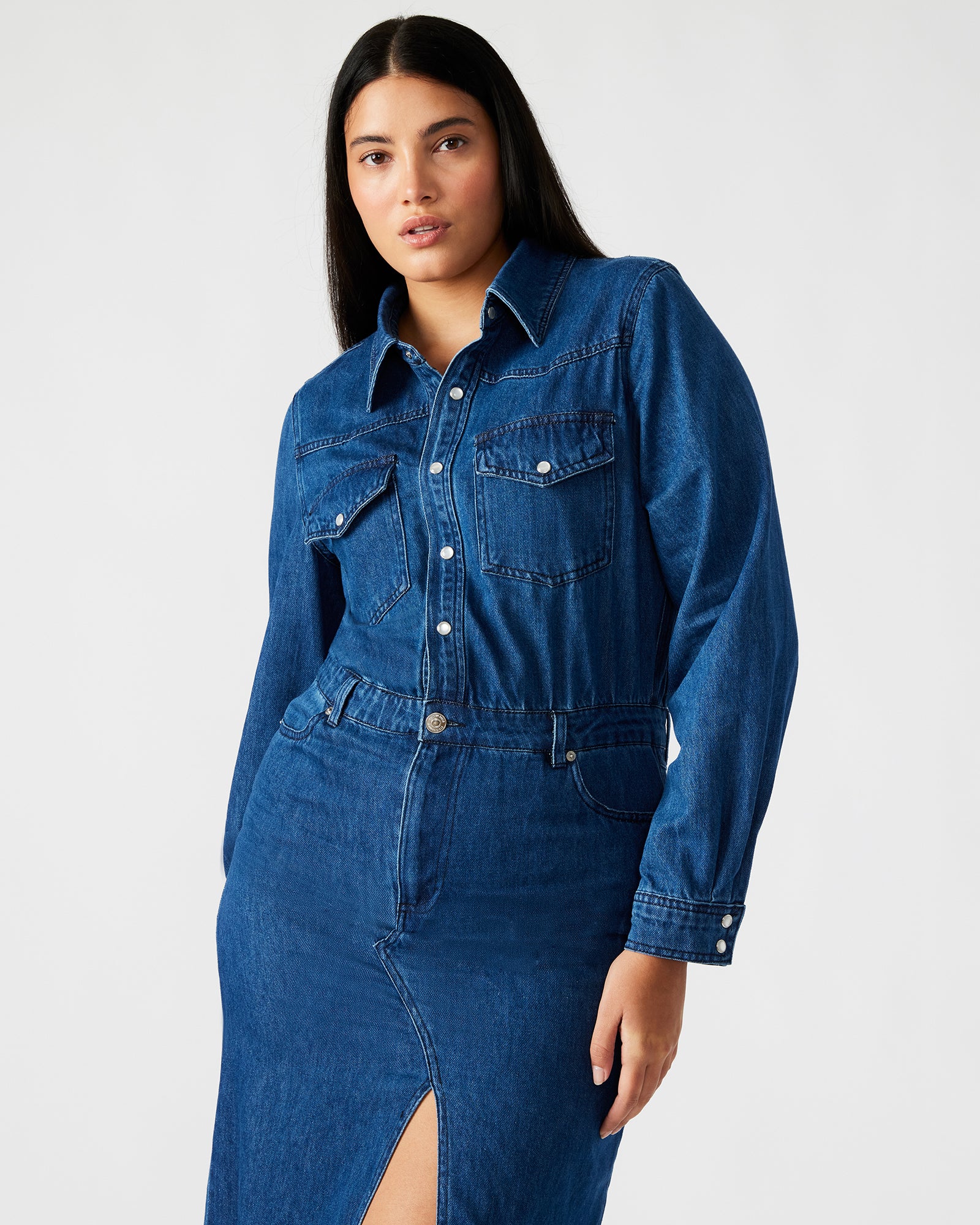 Close-up of the button-down front and pocket details on the denim dress