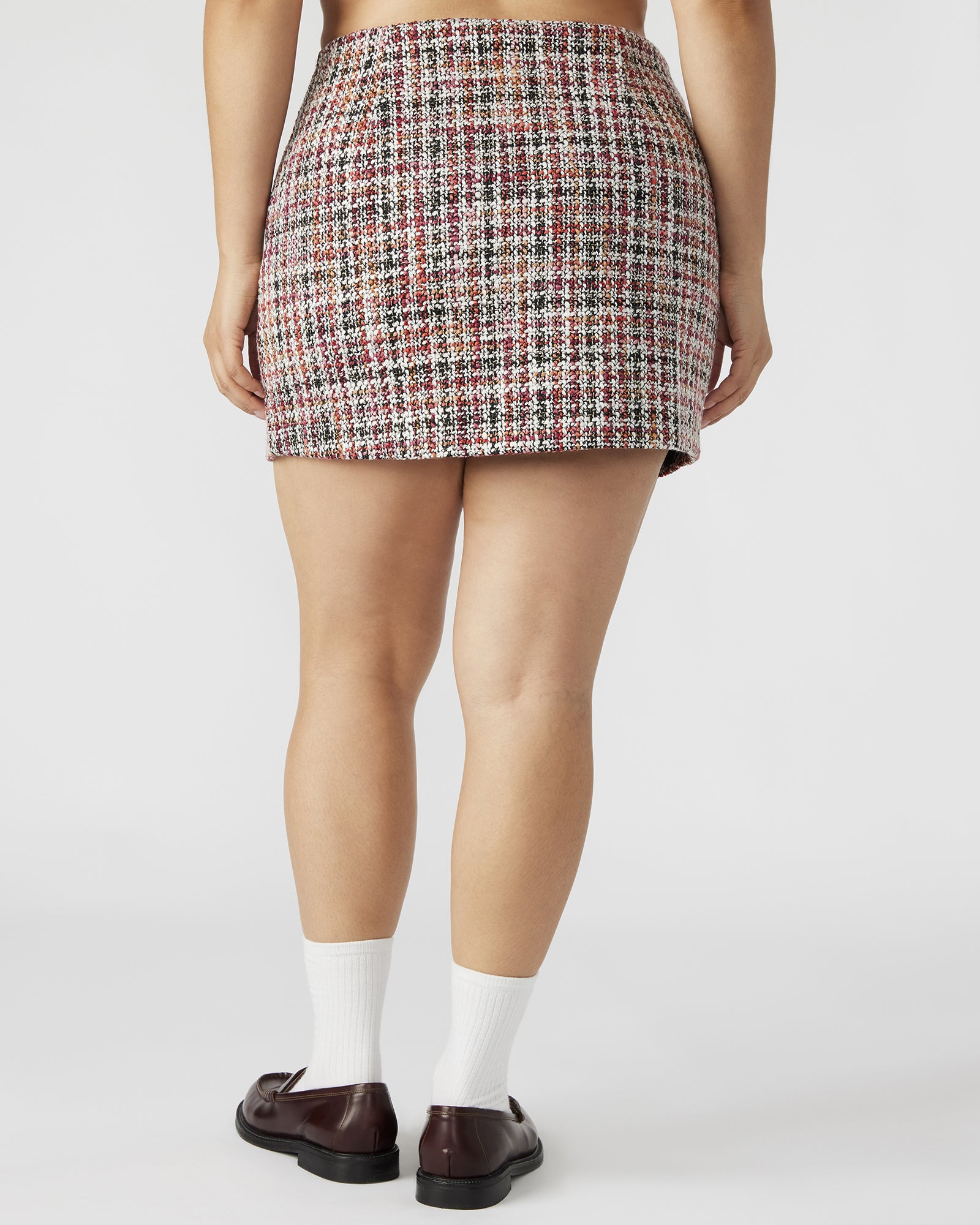 Side view showcasing the side zip closure of the MATTEA mini skirt.