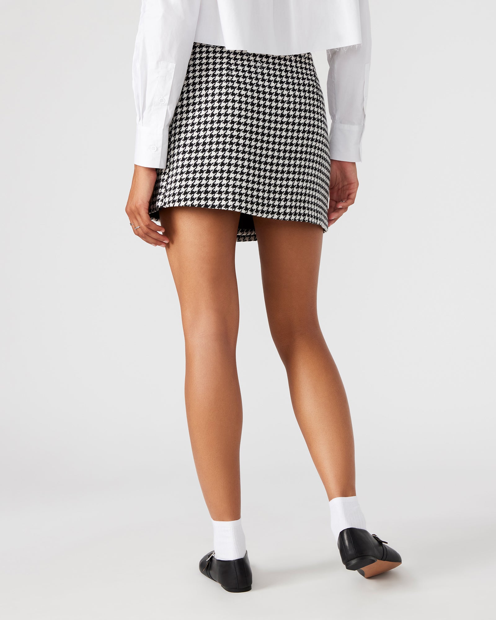 Full view of the mini skirt styled with boots for fall fashion