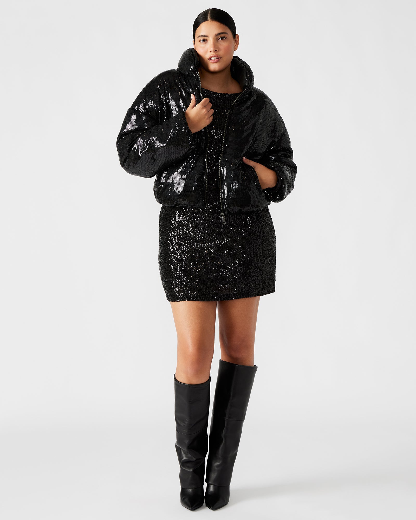Close-up of the zipper closure and sequin details on the womens puffer jacket.