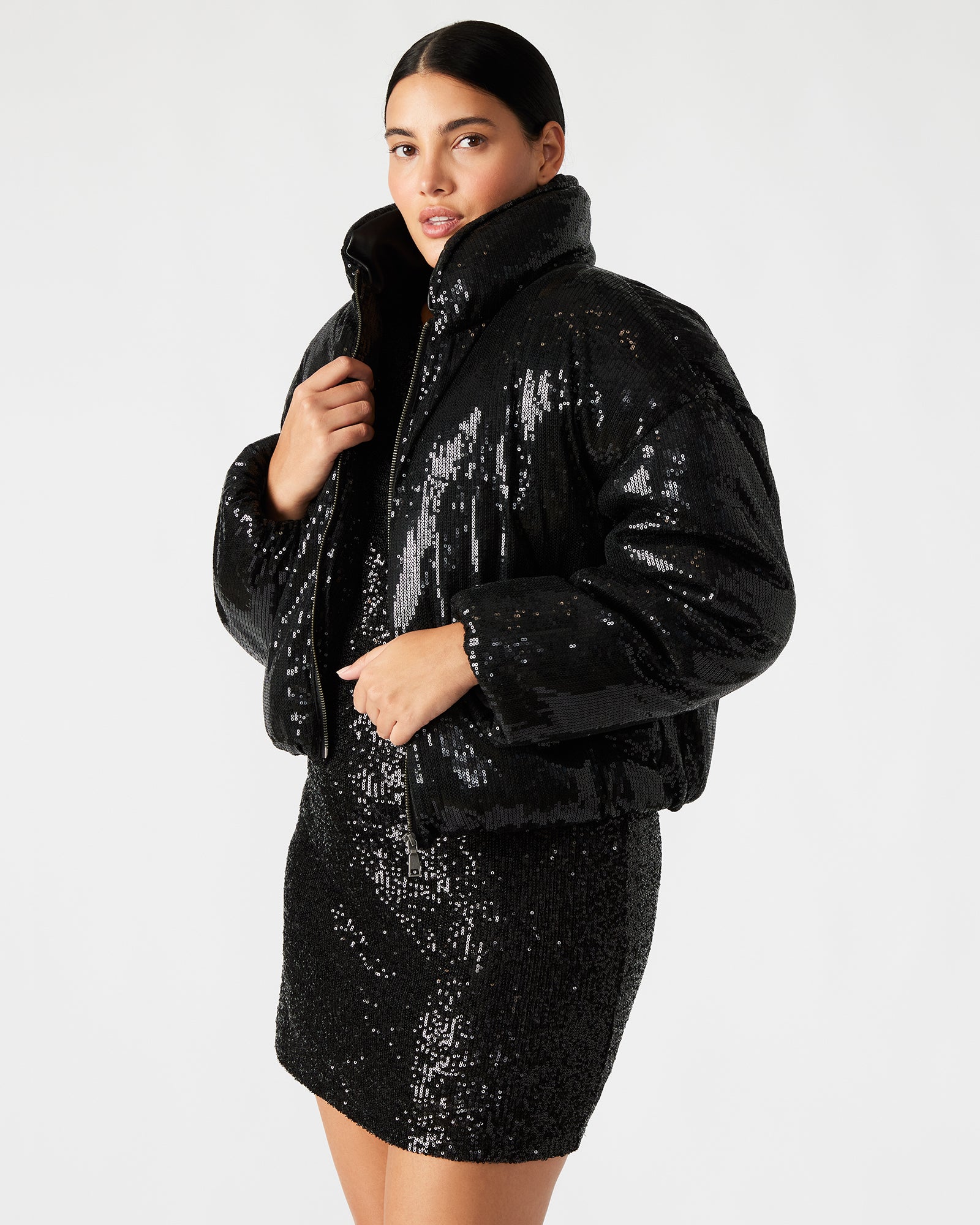 Close-up of the zipper closure and sequin details on the womens puffer jacket.