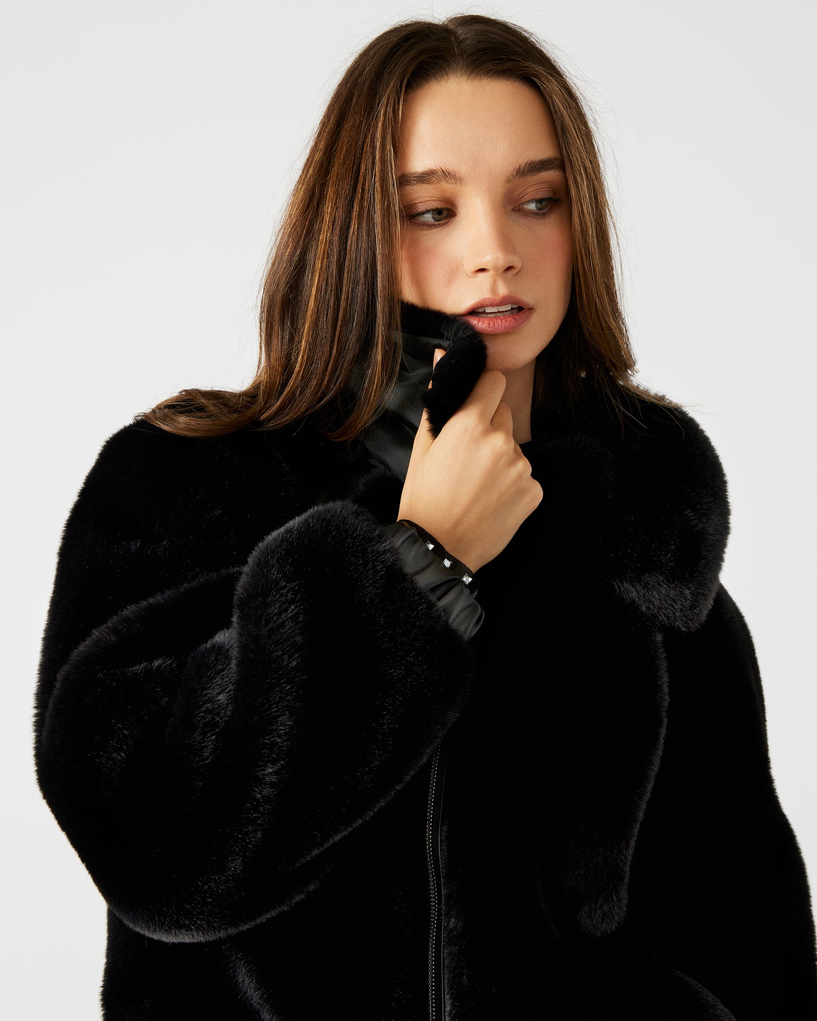 Side view of the black zip-up jacket, highlighting the collared neckline and long sleeves.
