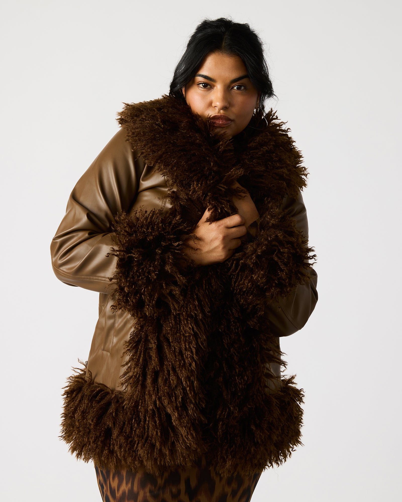 Back view of womens faux leather jacket highlighting shaggy collar and clean stitching