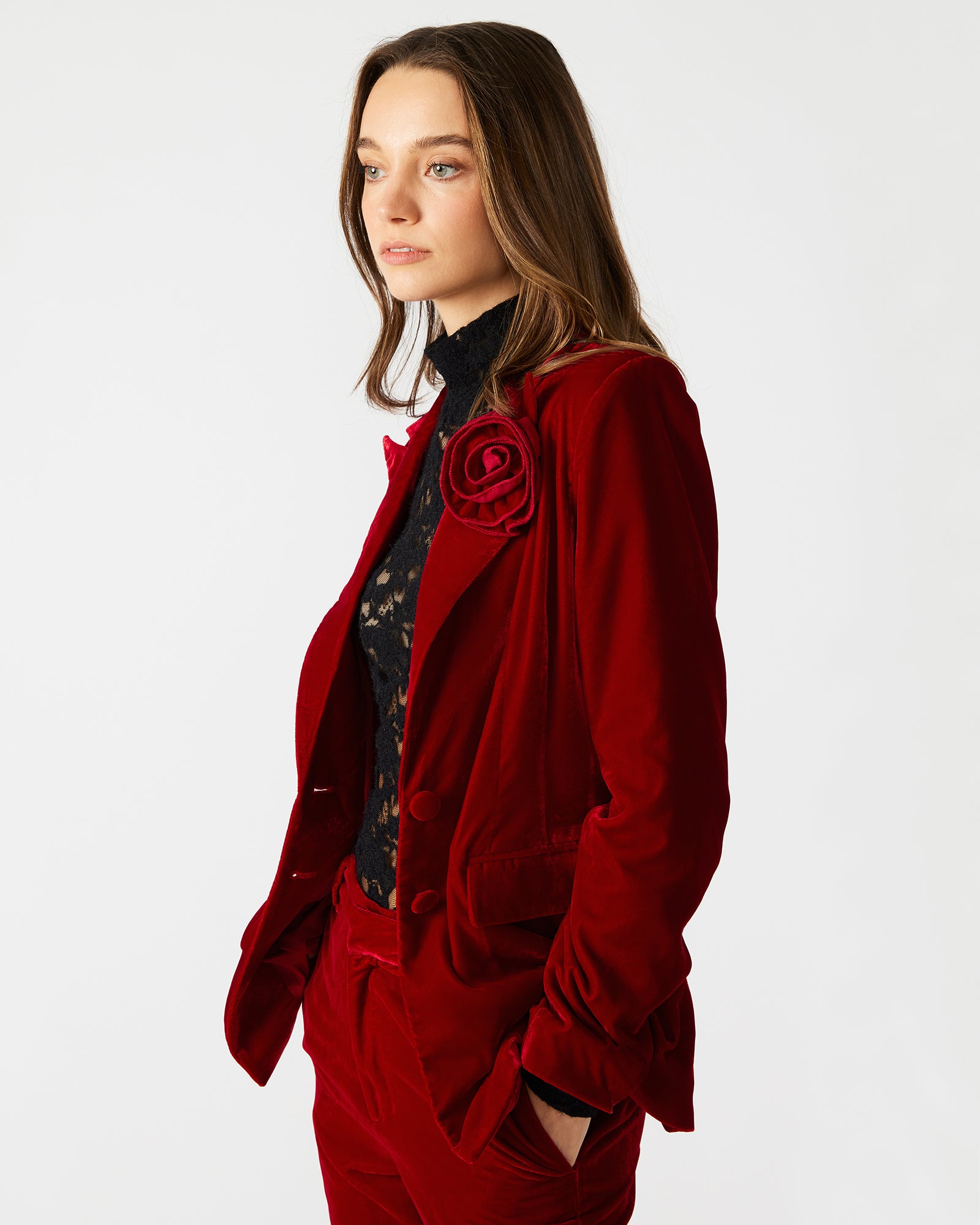 Side view of the long-sleeved red blazer, highlighting the button-up closure.