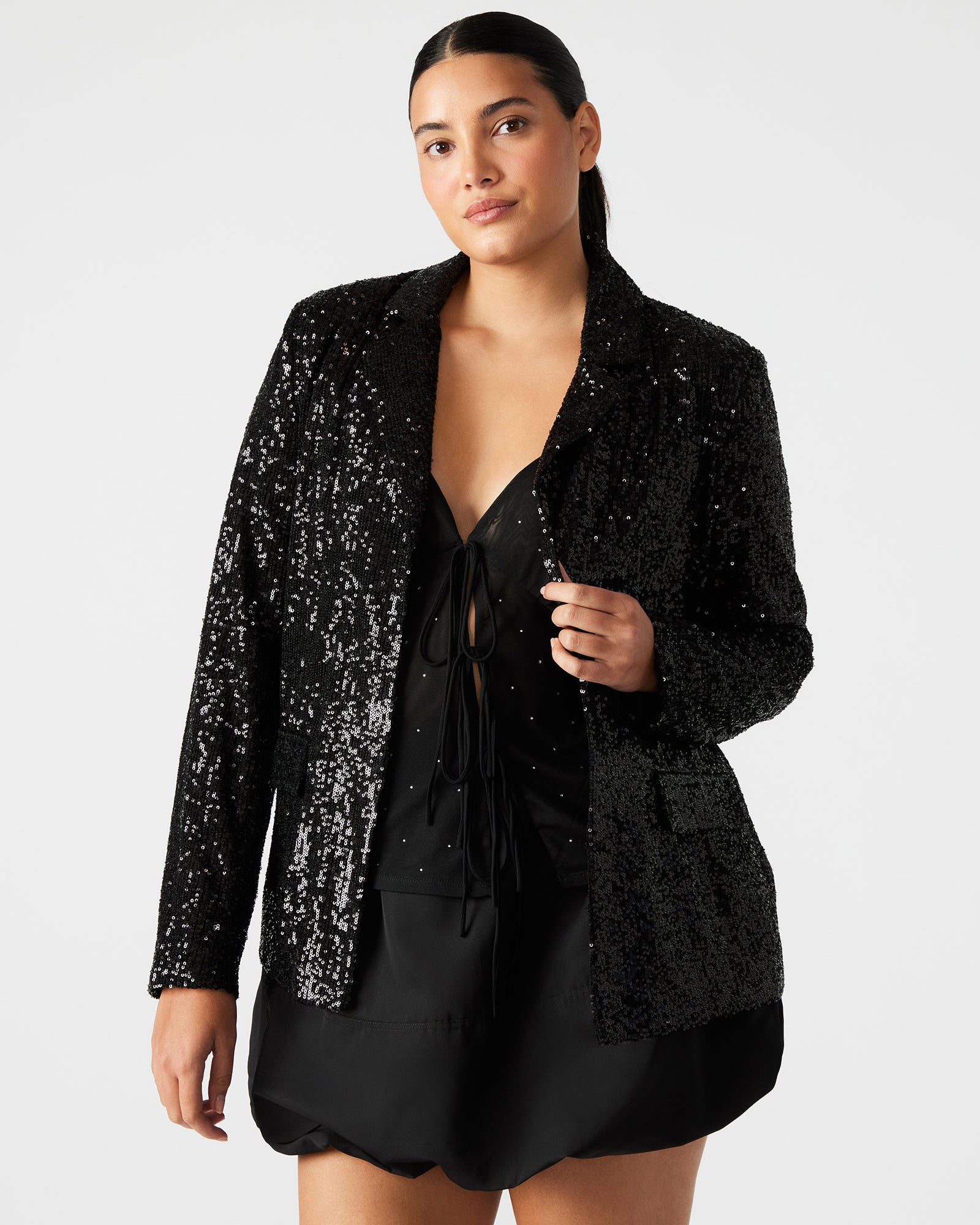Front view of male black blazer with silver sequins, styled for a rooftop party.