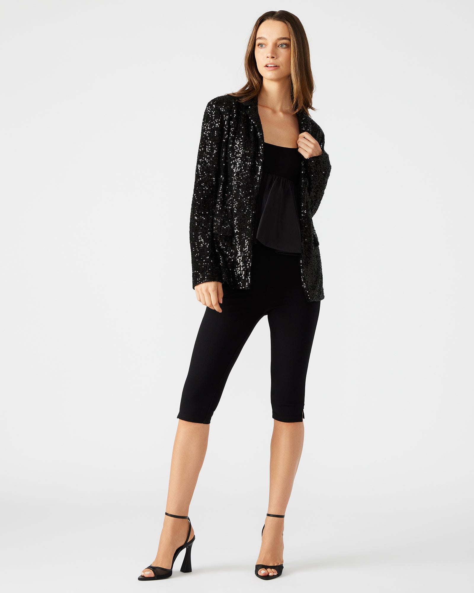 Front view of male black blazer with silver sequins, styled for a rooftop party.