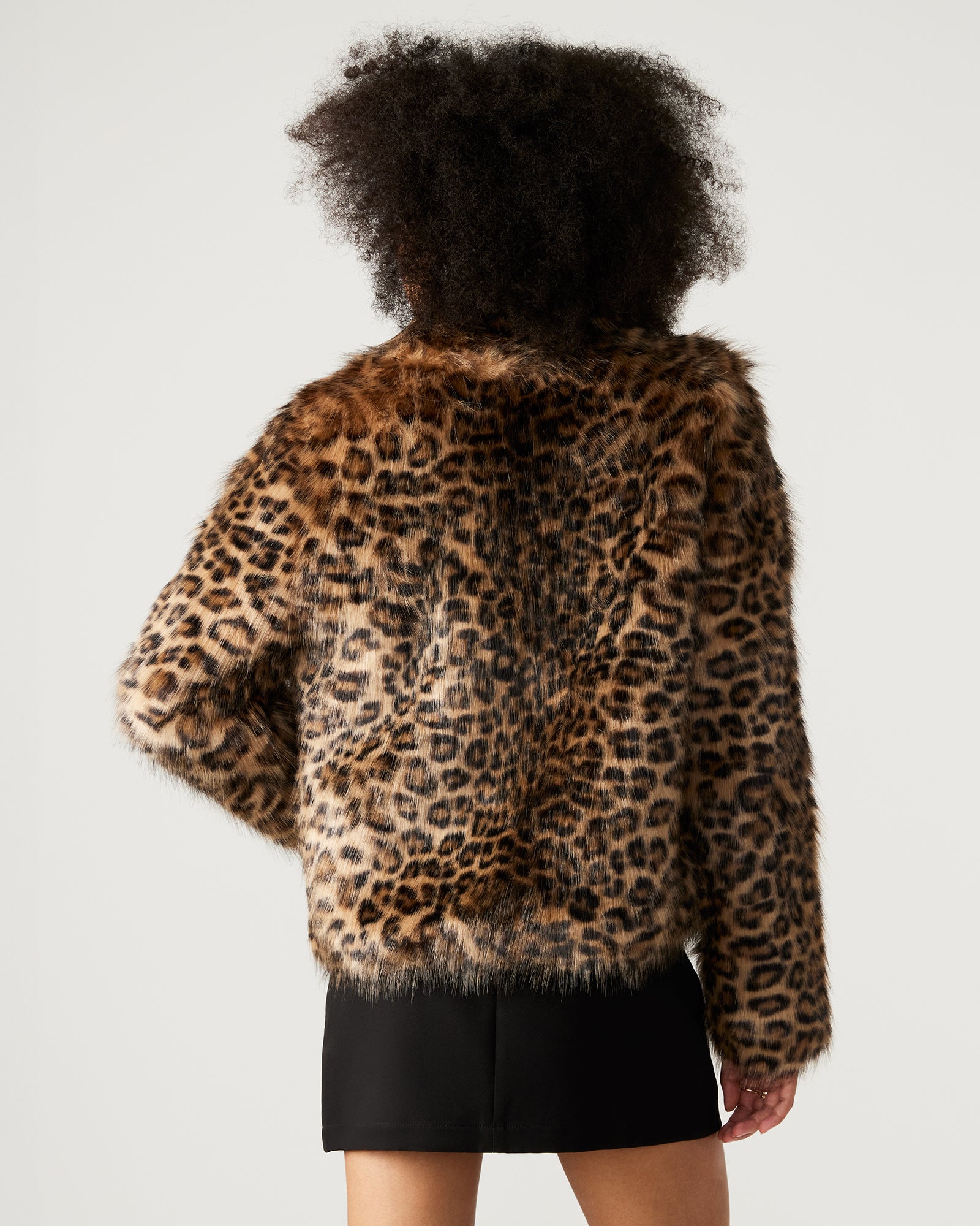 Side view of womens faux fur coat with collar and pockets