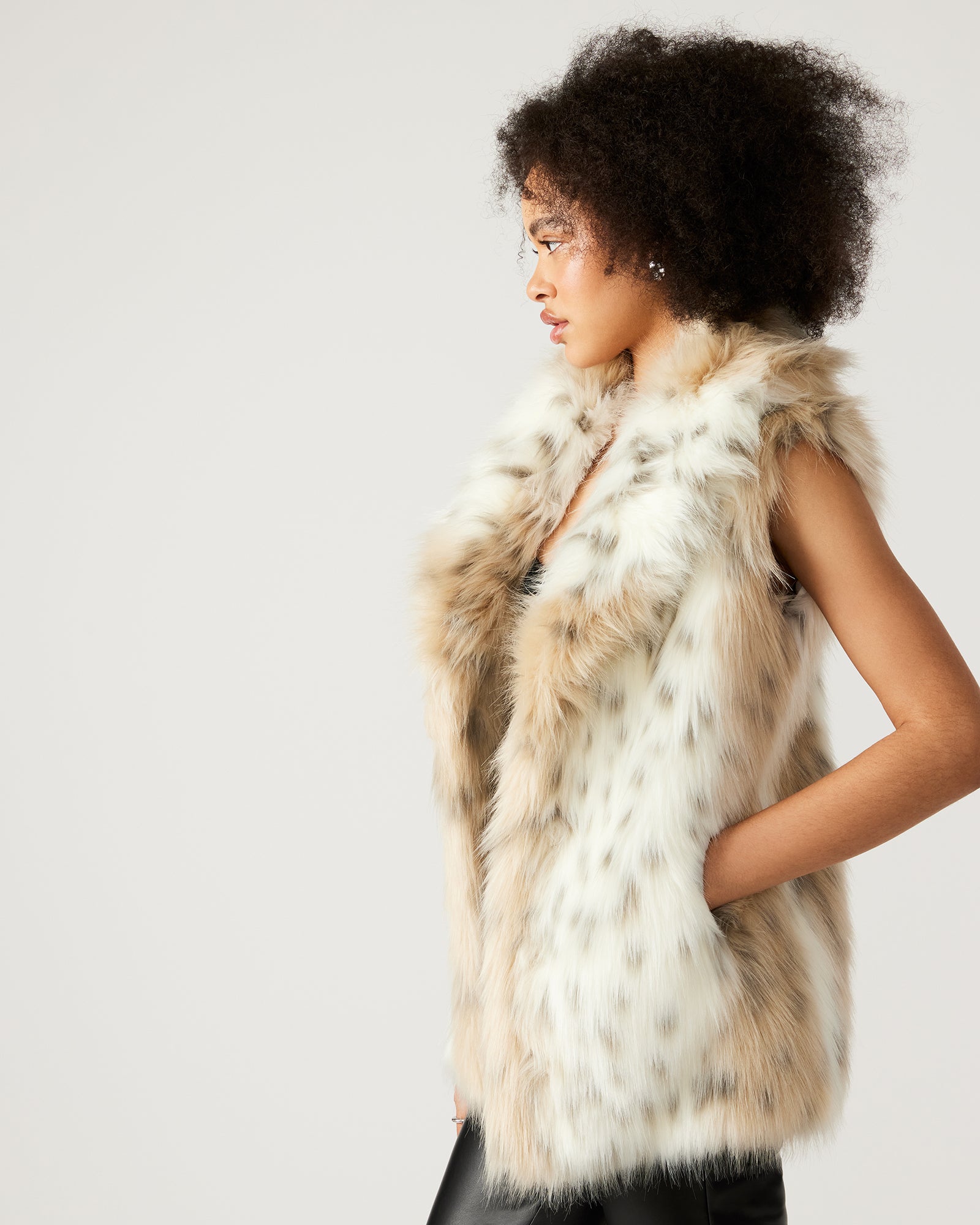 Closeup of ladies faux fur vest with snow leopard texture and soft collar