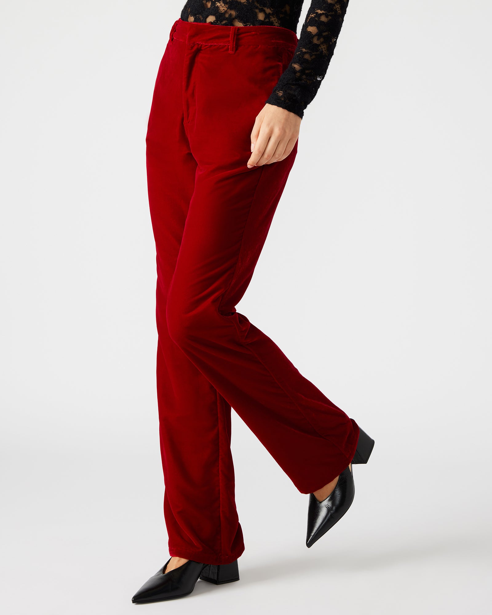Close-up of tailored trousers with side pockets in soft velvet fabric