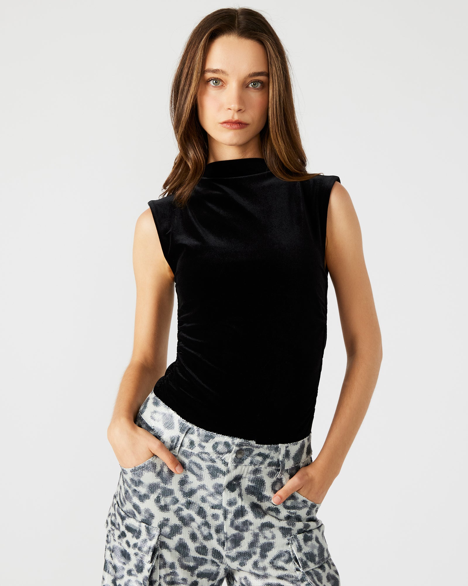 Close-up of the black velvet bodysuit showcasing the mock neck design.