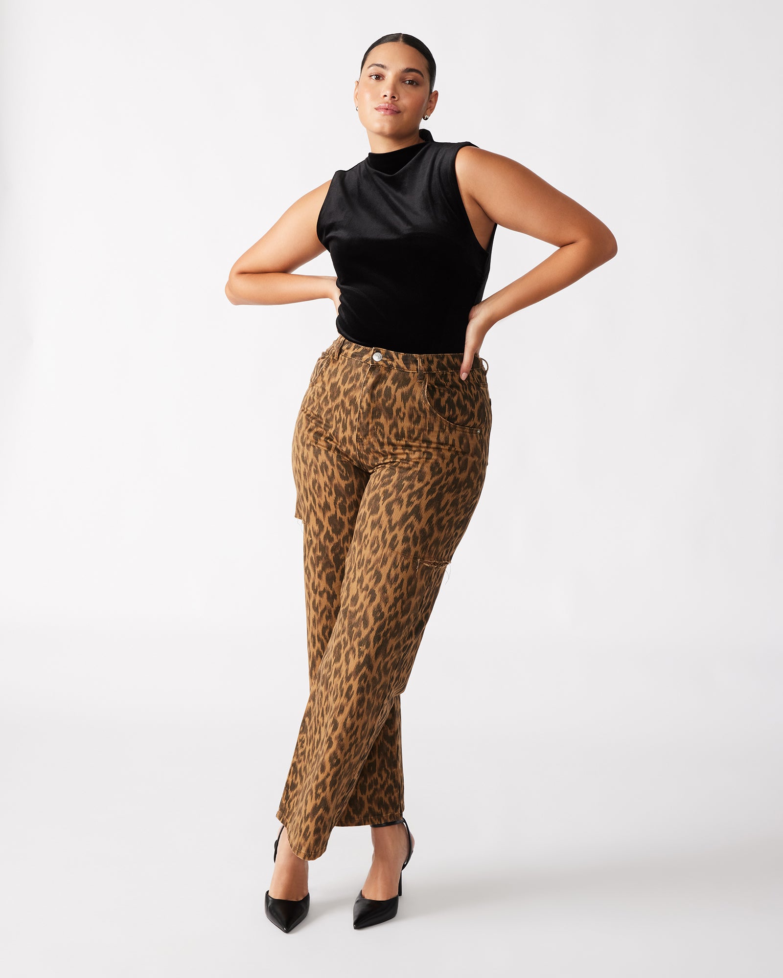 Model wearing the sleeveless bodysuit in a chic urban setting.