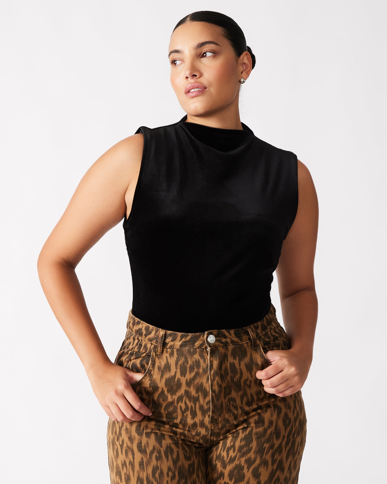 Back view of the black bodysuit highlighting the zipper closure.